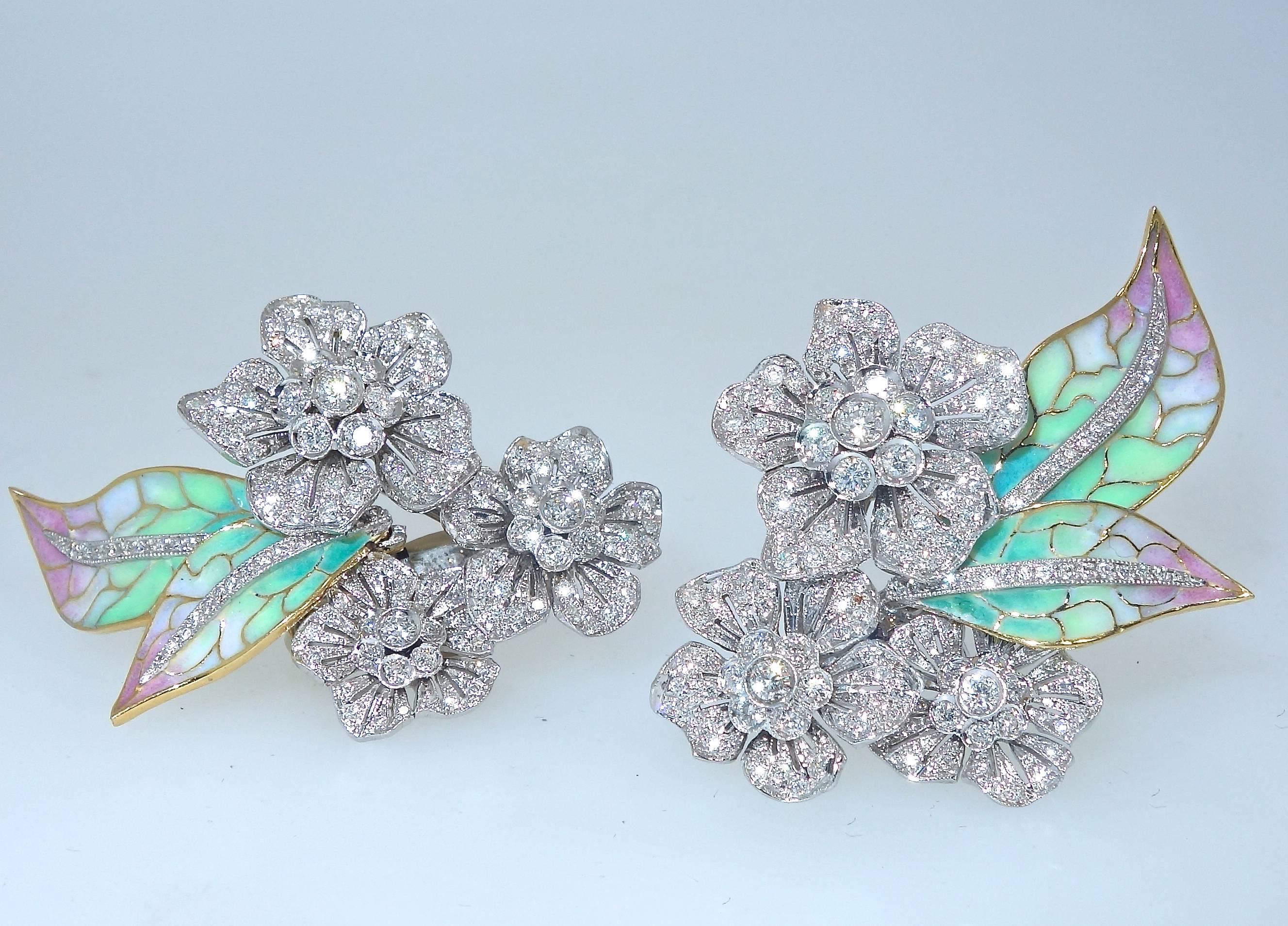 Plique a jour enamel leaves accent the diamond flowers creating a lovely earring.  The diamonds weigh approximately 4 cts.   They are well set with fine white color - near colorless (H) and very slightly included VS.  The shaded pink, green and