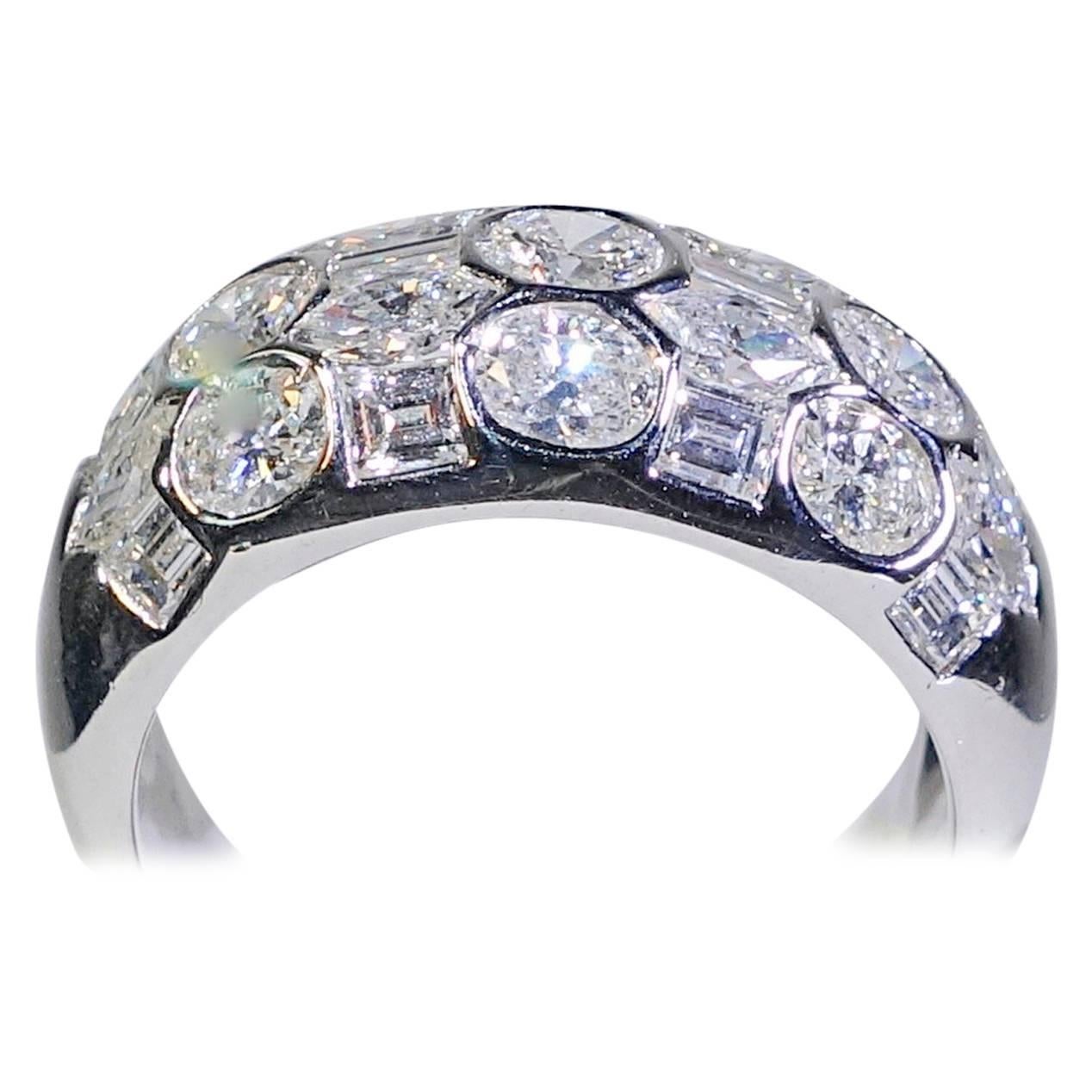 2.50 cts of fine white fancy cut diamonds are set into this 18K white gold band ring, signed and numbered by Beaudry. This ring is a size 5.5 and is sizable.