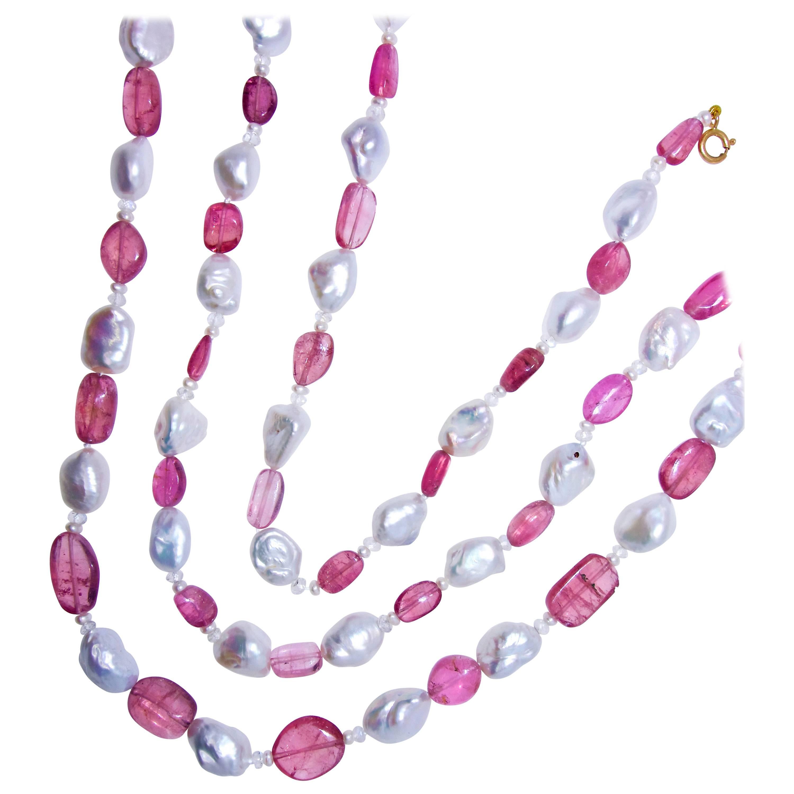 Pink tourmalines are all a bright pink and lively color, 42 stones, slightly graduating in size and amounting to approximately 175 cts.  Interspersed are 40 natural baroque pearls ranging in size from 9.5 to 12.5 mm.  There are also small natural