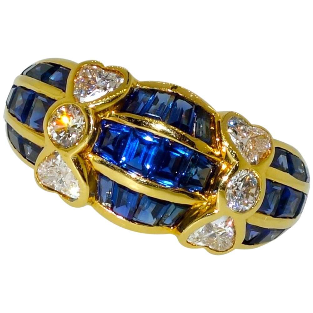 Van Cleef  & Arpels has designed a charming ring with fancy cut fine blue sapphires interspersed with fine white diamonds - both round and heart shaped.  These diamonds are white, colorless (F) and very very slightly included (VVS).  The calibre cut