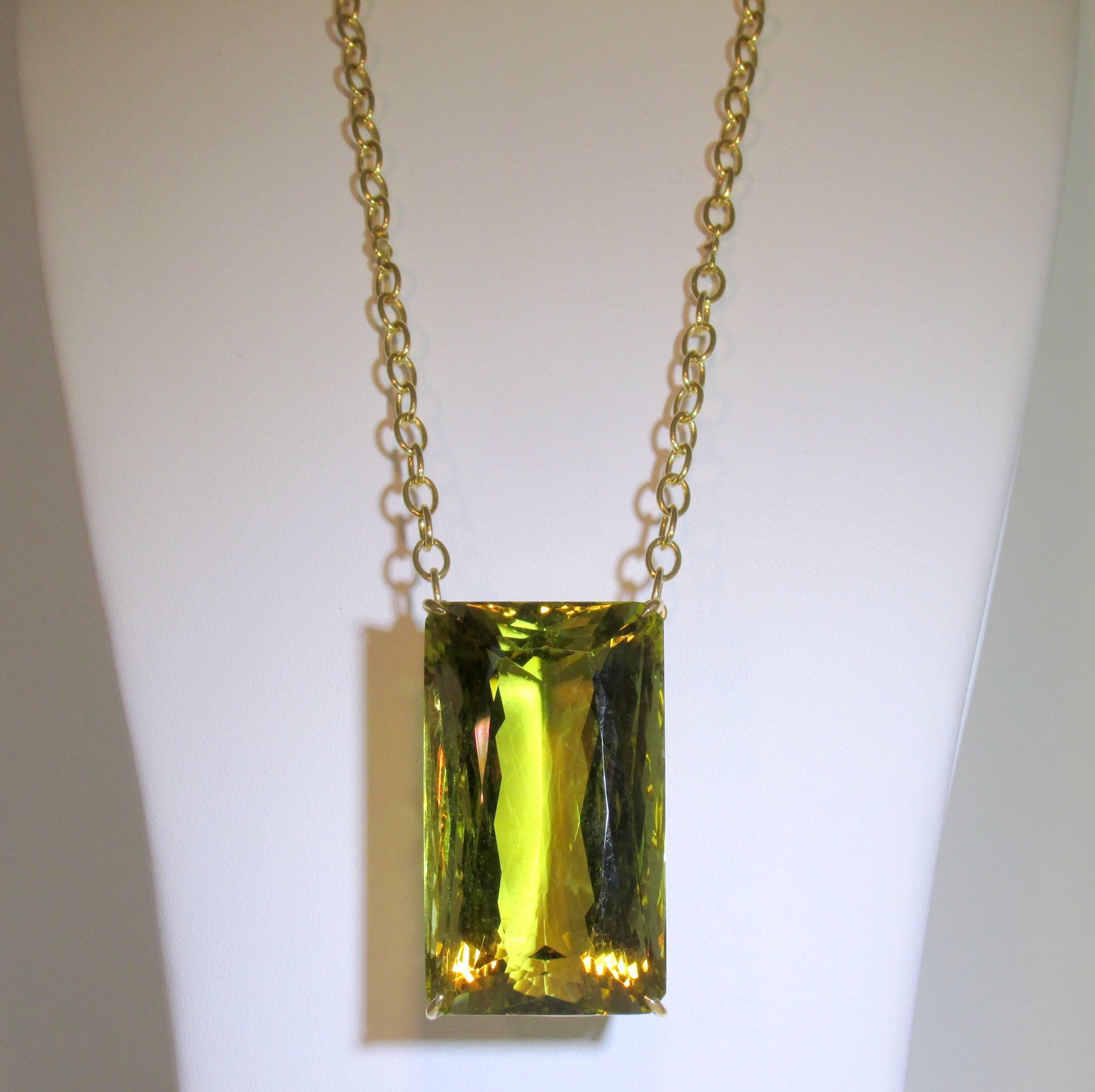 18K yellow gold necklace possessing a rectangular shaped  lemon quartz prong set with a fancy basket.  The stone weighs 201.85 cts and is clean and bright.