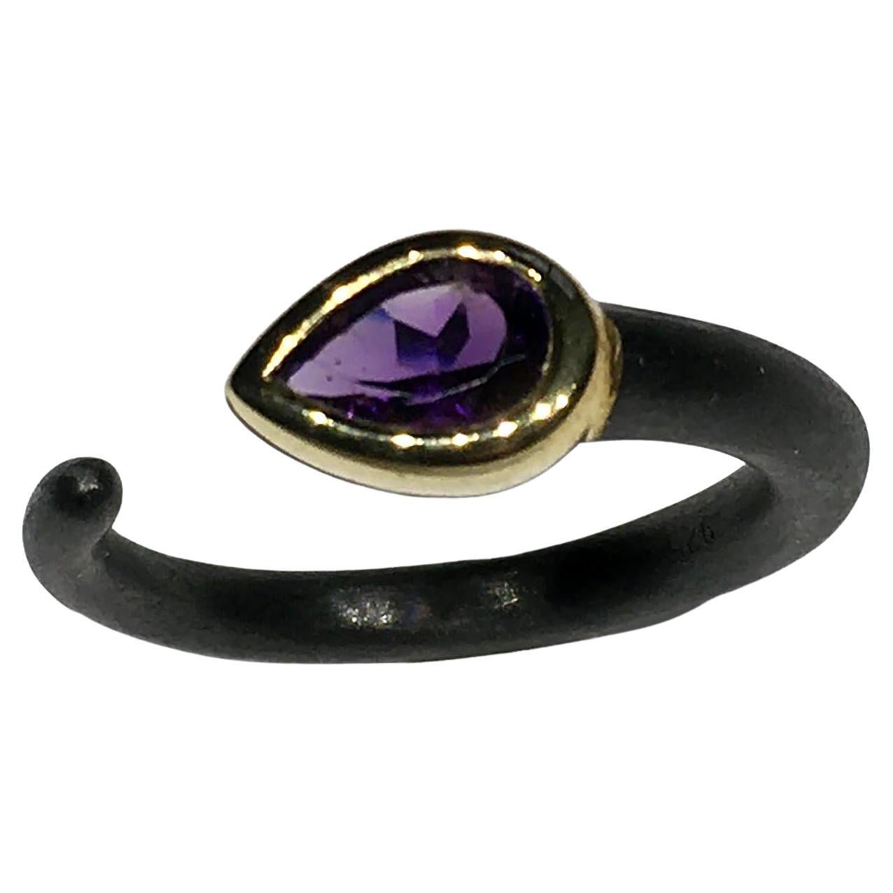 An Amethyst Ring Set in Gold Plated Bezel in a Blackened Silver Band