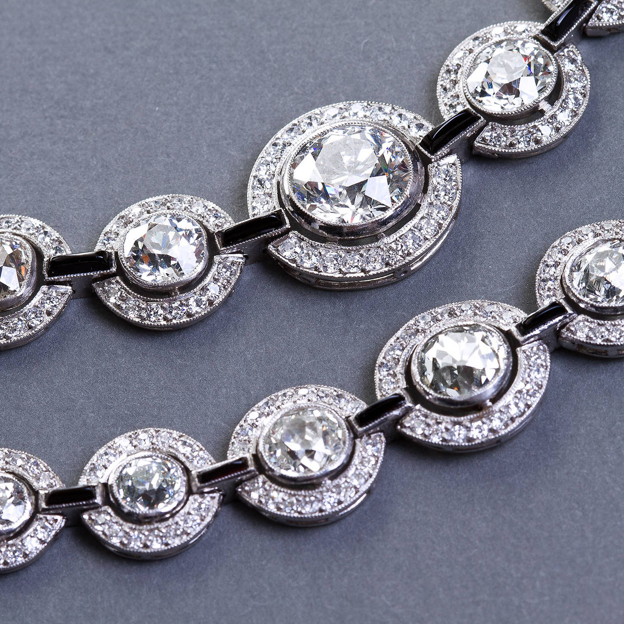 A very fine diamond and onyx link in platinum necklace and bracelet set from the Art Deco period. 
Approximately 30 carats of diamonds total. Necklace contains a center stone approx. 3.00 carats J (Near Colorless) color VS2-SI1 clarity with a