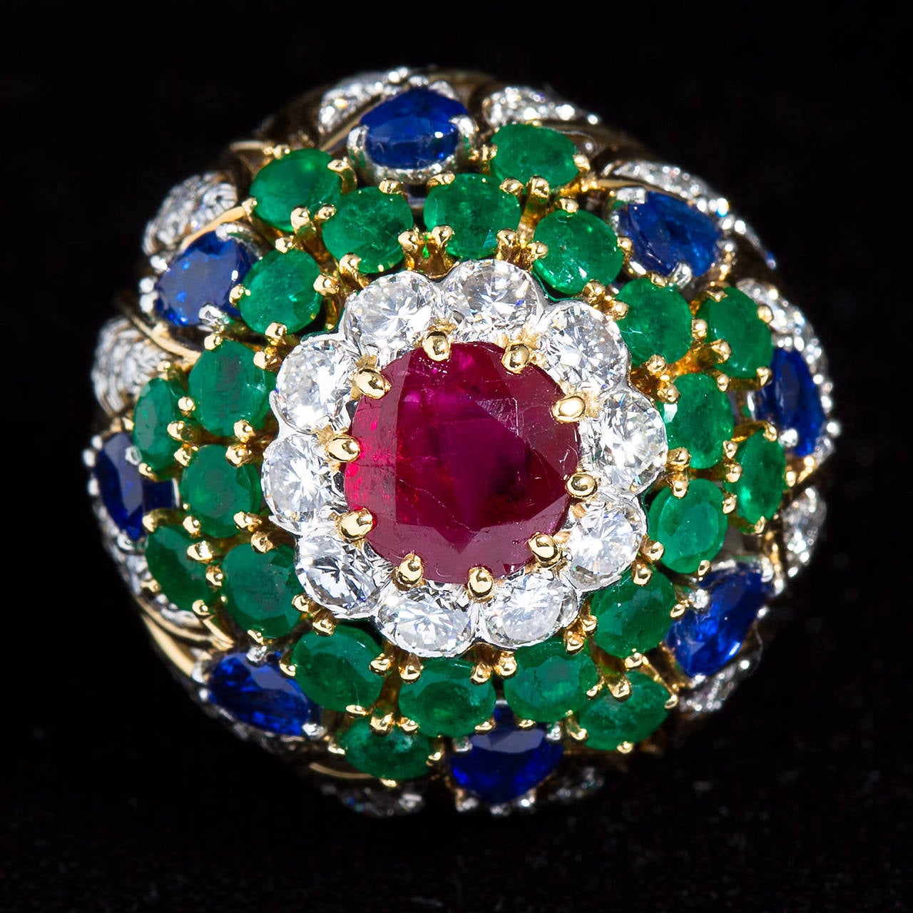 A diamond and multi-gem in 18k gold elaborate dome ring by David Webb.
Contains round brilliant diamonds, sapphires and emeralds with one center round brilliant cut ruby.

Dealer ref No. 6527