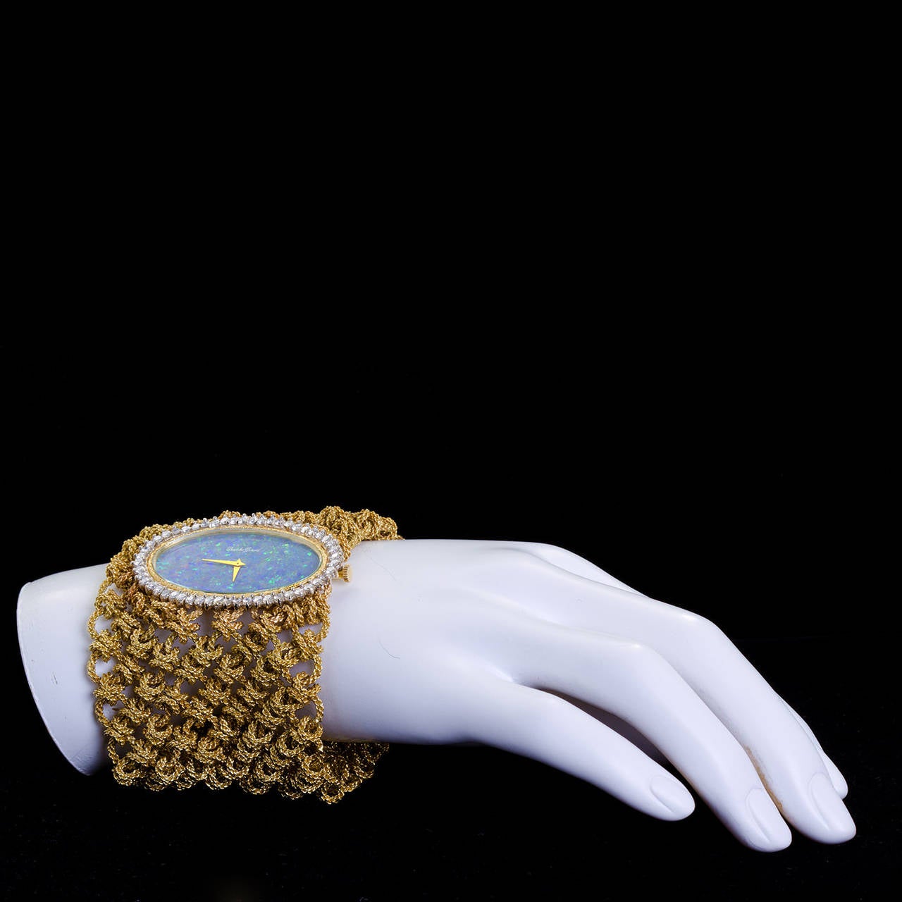 Bueche-Girod lady's 18k yellow gold woven mesh wide bracelet watch with opal dial and diamond bezel. Circa 1970s.

Dealer Ref. No. 6254