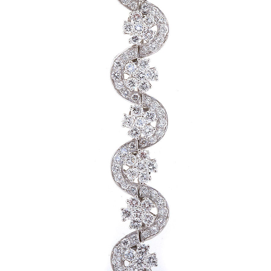 A very fine serpentine design diamond and platinum bracelet with approx. 10.00 ctw by Oscar Heyman. Signed and numbered. 7 inches long. Excellent price for such a bracelet.

No. TMWJ-3571