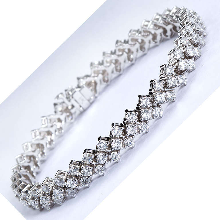 A three row diamond in 14k white gold tennis bracelet containing 111 round brilliant  cut diamonds weighing 7.76cts total. Diamond color H-I, clarity SI1. Measures 7