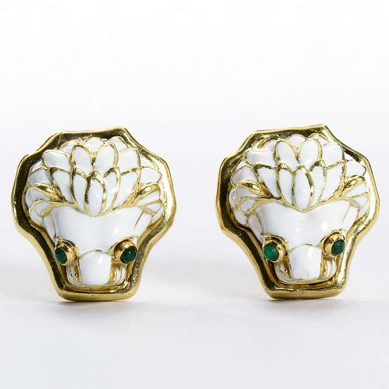 A pair of 18kt yellow gold and white enamel lion head ear clips with cabochon emerald eyes by David Webb. Signed WEBB.

Dealer ref No. 5814
_
TMW Jewels Co. is a family owned jewelry seller in the heart of New York City's jewelry district.