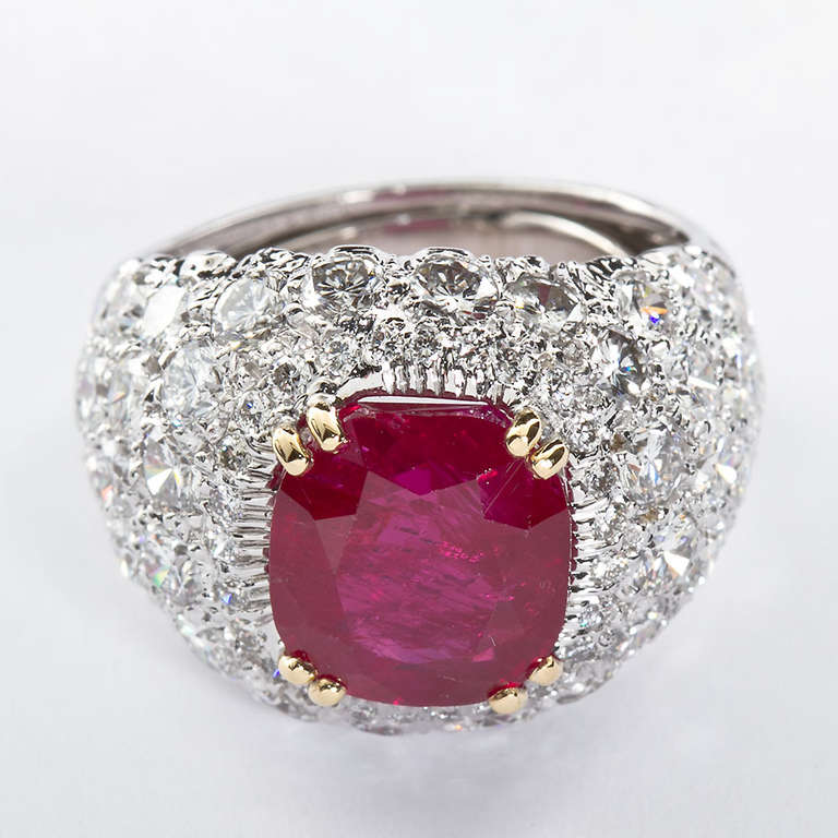 An 18k white and yellow gold and diamond ring featuring a single rare Burmese non-heat-treated cushion cut 5.77 carat ruby. The ruby is an exceptional deep red. Contains ~4.00 carats of collection quality diamonds.  Signed Webb for David Webb. 