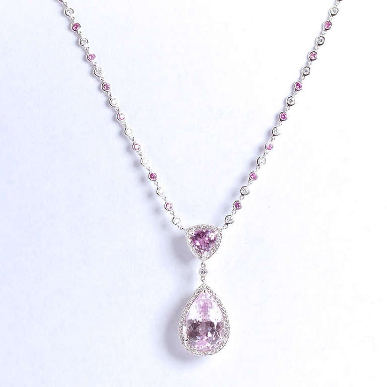 Oh what fun it is. And in pink! A pear shaped kunzite pendant in 18k white gold and surrounded by  a pear shaped diamond halo border. The chain is set with alternating bezel set kunzite and round brilliant diamonds.

Pendant total height 43 mm. 