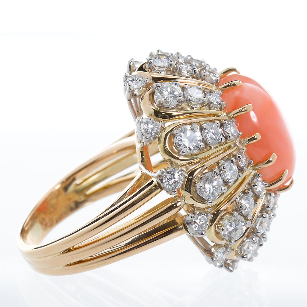 A fabulous diamonds with center cabochon coral cluster cocktail ring in 18k gold and platinum with approx. 3.00cts of diamonds created by OSCAR HEYMAN.

Dealer ref No. 4947
