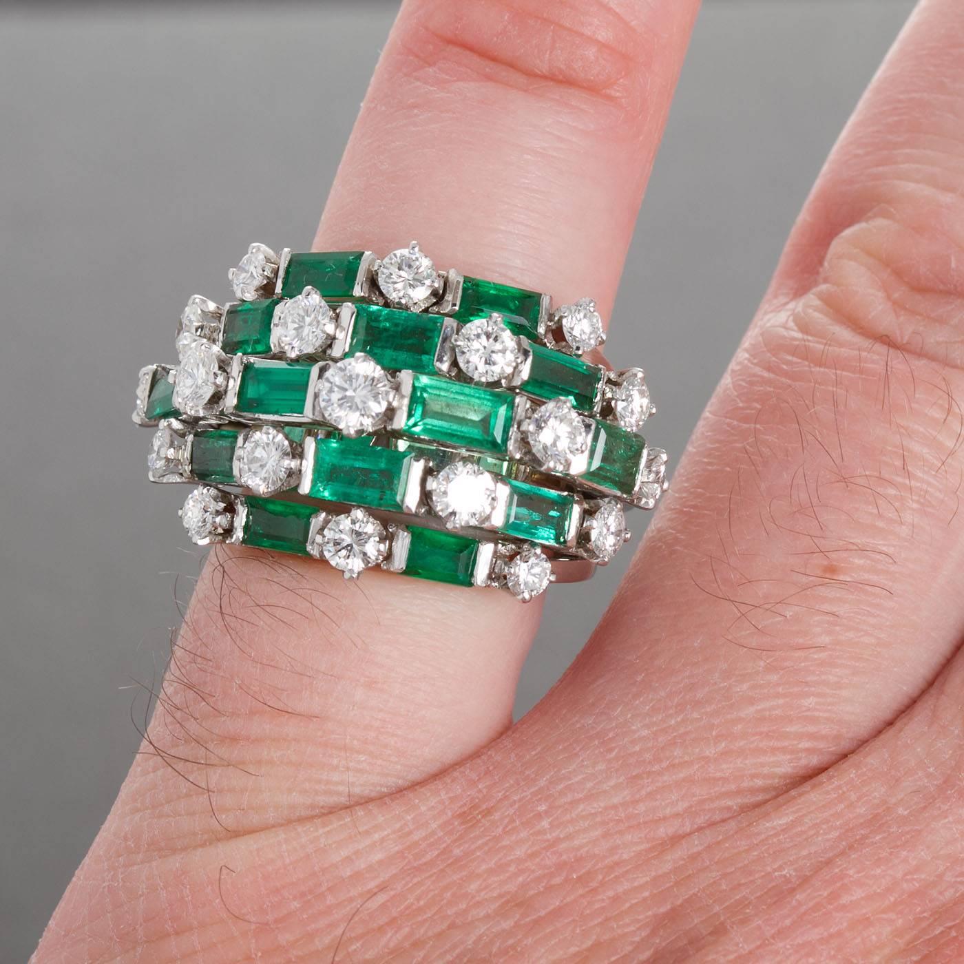 A fine diamond and emerald cocktail ring. Contains 19 round brilliant diamonds and 14 rectangular step cut emeralds set in platinum. Diamonds are ~2.30 ctw.  Emeralds are ~3.50 ctw. Currently size 5-1/2 US and complimentary resizing from 3.5 - 8