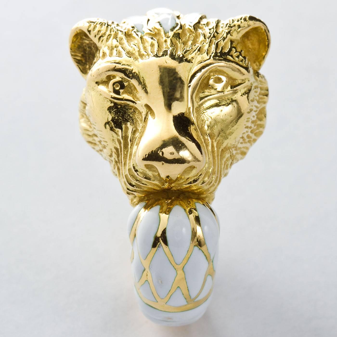 An 18 karat yellow gold and white enamel fashion ring.  Formed as a Lion's head with a white enamel on gold mane ended by enameled paw style ring tip. Signed WEBB. by David Webb.

Ring size 5-6, resizable to fit cost-free.

No. TMWJ-6565