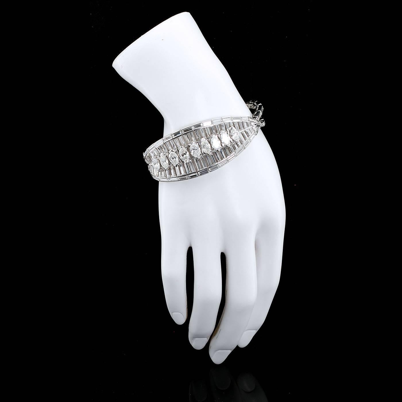 This remarkable circa 1960s bracelet puts your best hand front and center. Exquisite finely crafted platinum channel settings contains 130 calibrated straight diamond baguettes designed as both a trailing border and background to the center tufted