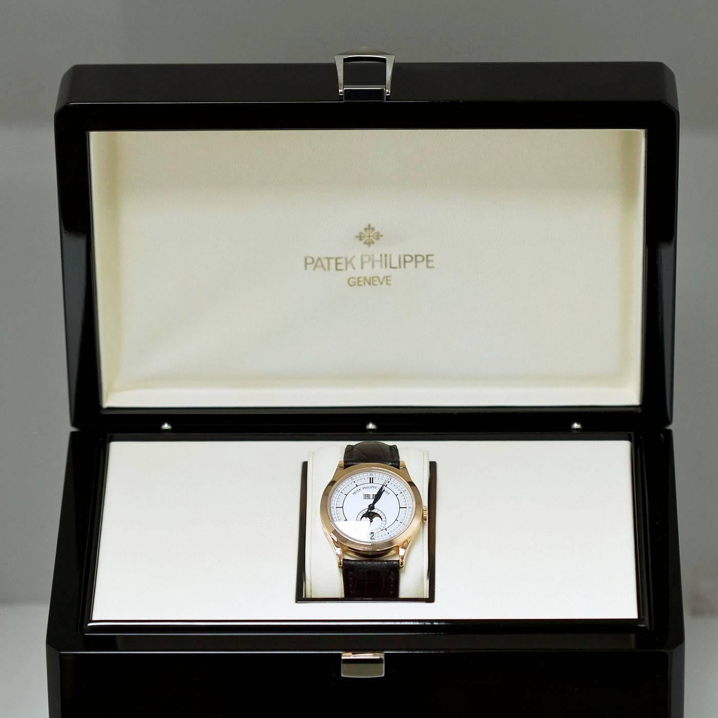 This Patek Philippe watch is in very good to excellent condition. Annual Calendar and Moon Phases. 18k rose gold case with transparent back. Patek 18k rose gold deployment buckle. 
Original brown exotic strap with slight creases. Comes with the
