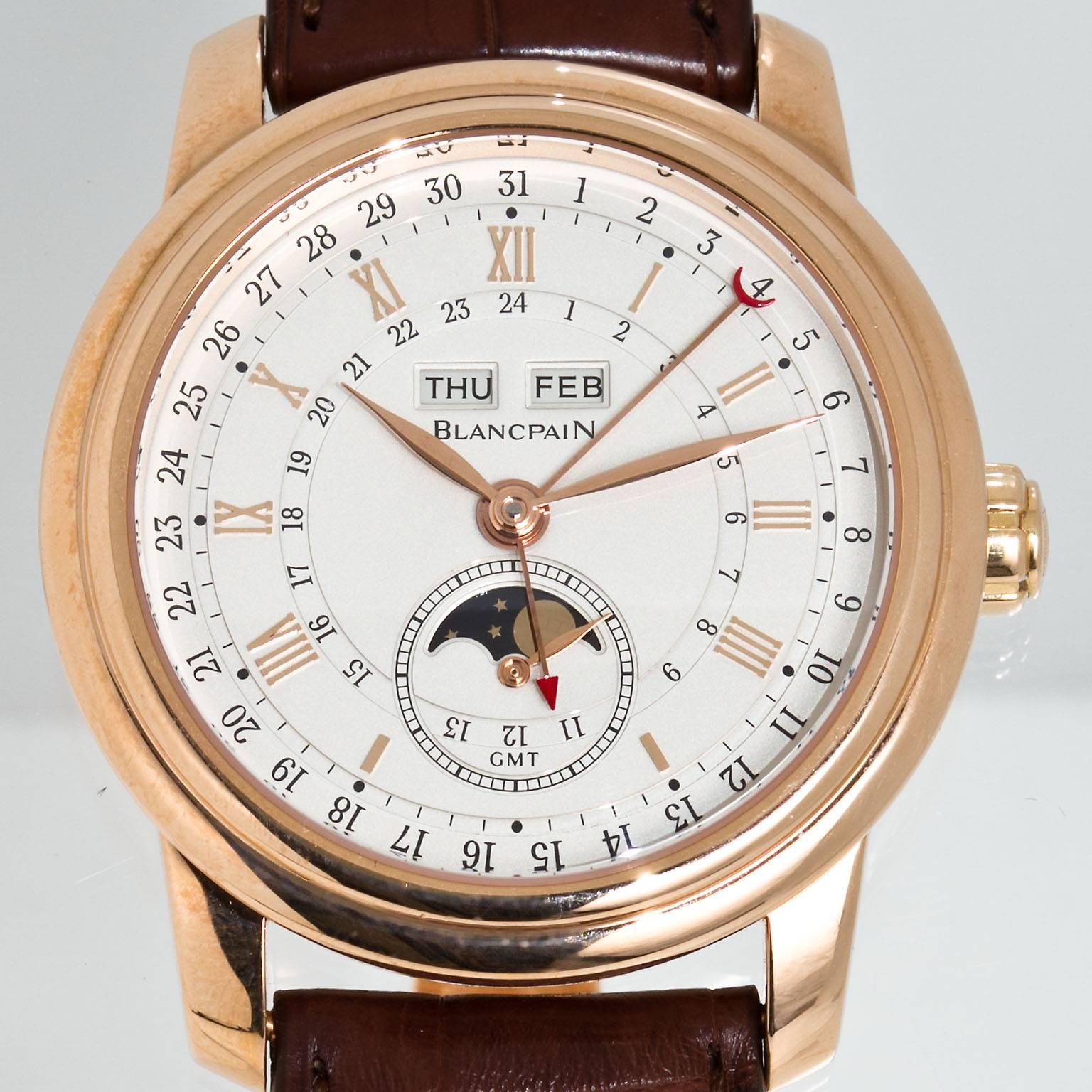 A Blancpain Le Brassus Complete Calendar GMT watch, round 18kt rose gold case (42mm diameter, 13.3mm thick), strap is brown crocodile leather.  A white opaline dial with 18kt rose gold Roman numerals and hands, complete calendar, GMT, moon phase