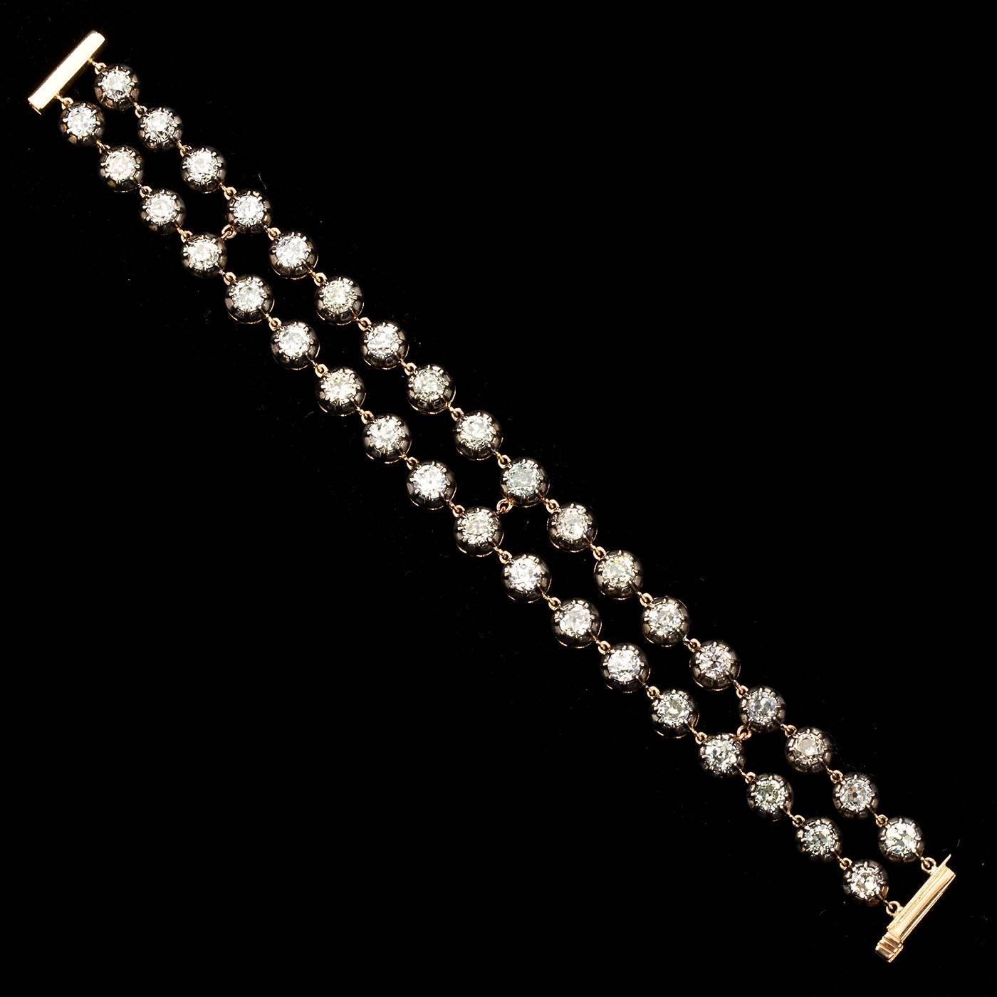 A remarkable antique style silver-on-gold double row Tennis bracelet with 36 old European diamonds weighing 20.80 ctw. Diamonds are high clarity (VS) and range in color from H-J color.  An exceptional find.

Measures 7-1/4