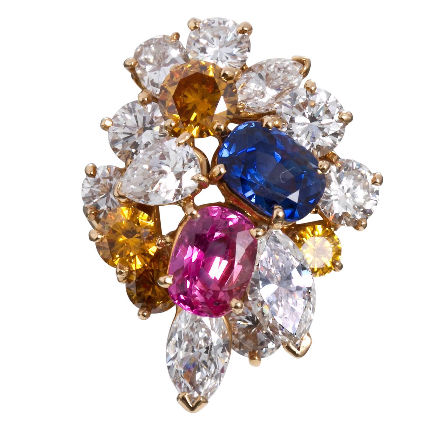 A superb diamond and sapphire ring in 18 karat yellow gold by Oscar Heyman Circa 1968.  Contains one oval brilliant blue sapphire 1.80 ct; one oval brilliant pink sapphire 1.58 ct; Five pear shape and marquise shape diamonds 2.40 ctw; six round