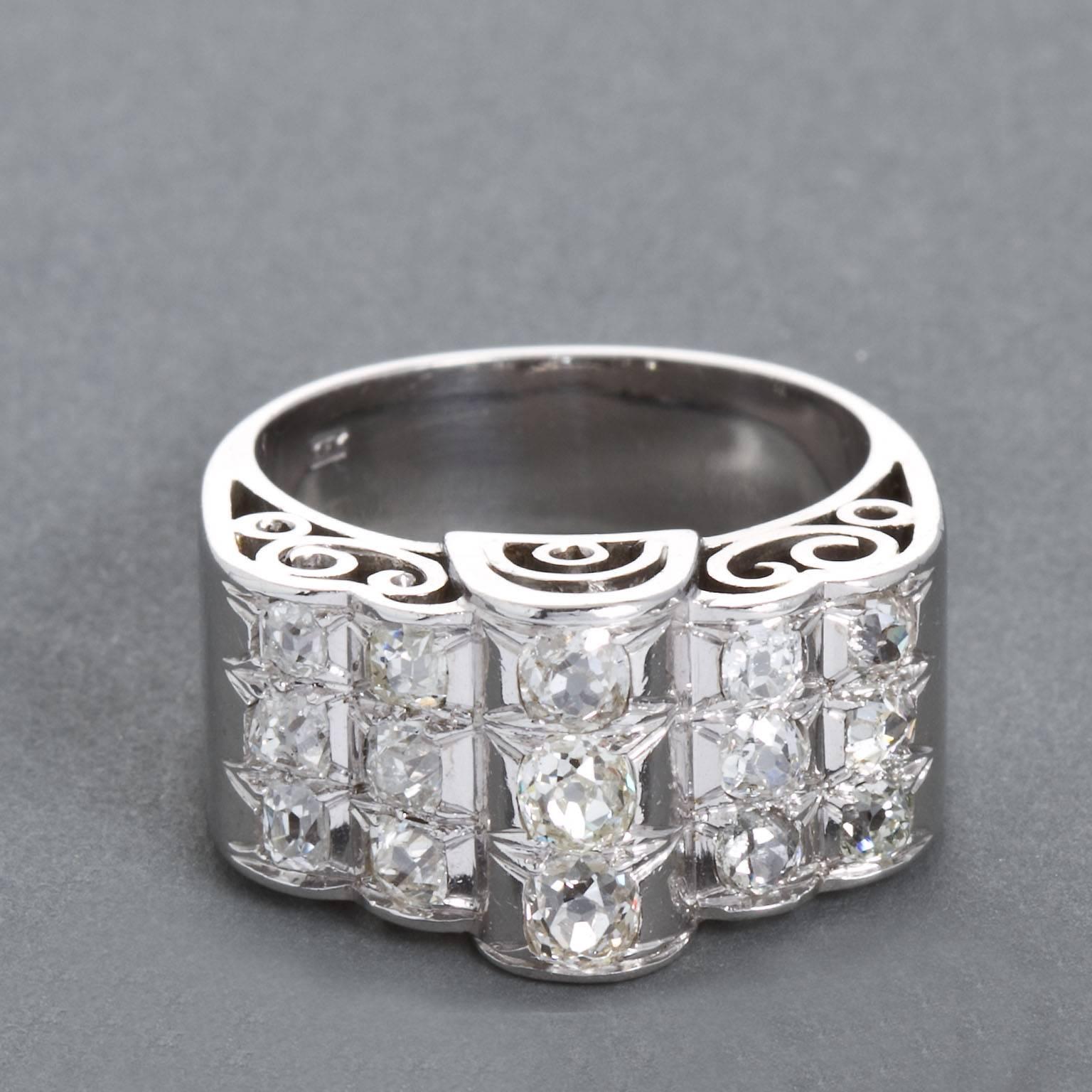A 14 karat diamond in white gold  ring.  Set with 15 old miner cut diamonds of approx 1.80 ctw.  Gallery side is designed with a filigreed motif.

No. 3729