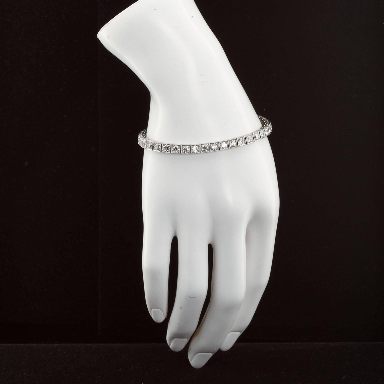 A very fine diamond in platinum tennis bracelet. Filigree boxed prong settings contain 39 stones (8.58 carats) of very fine F-G color VS clarity diamonds. Art Deco stylized bracelet sides.  Bracelet measures 7.25 inches long by 3/16" wide. 

No