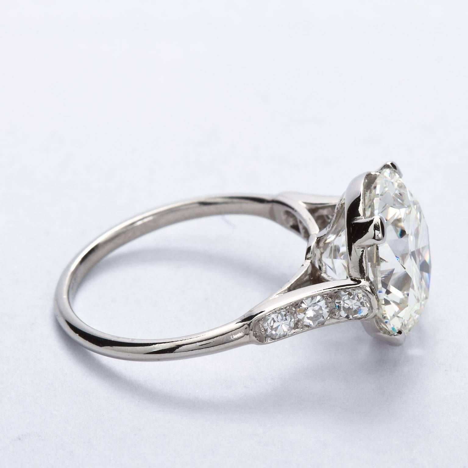 A very fine 4.41 carat round brilliant cut diamond, H color, VS2 clarity with accompanying GIA Report set in a fine white gold and diamond ring stamped with French hallmarks and partially worn 