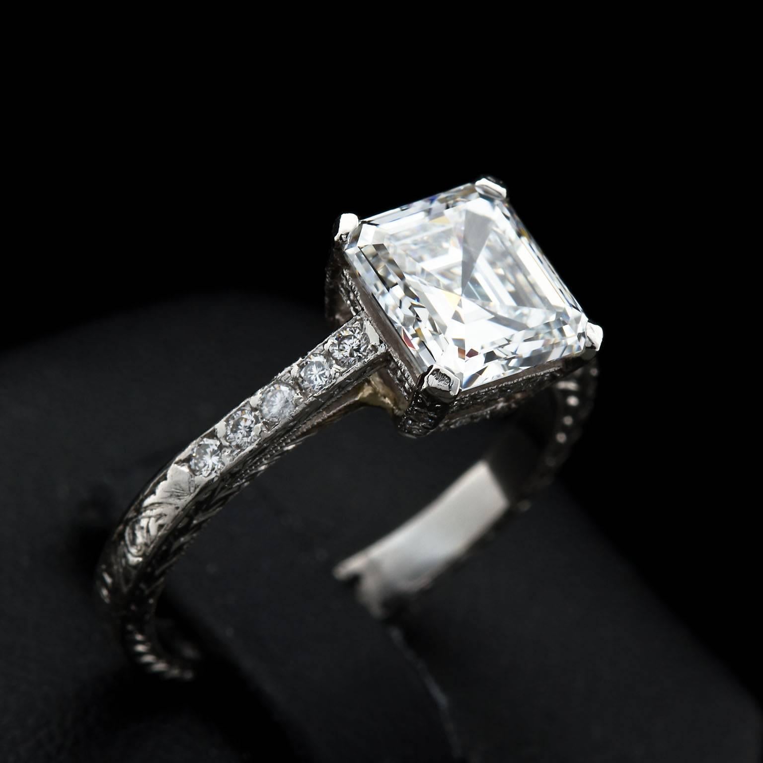 A vintage diamond in platinum engagement ring set with a center 2.52 ct. E color VVS2 clarity (GIA certified) square emerald or Asscher cut diamond and ten round diamond side stones weighing approx. 0.30 ctw.  The ring is a four-prong basket style