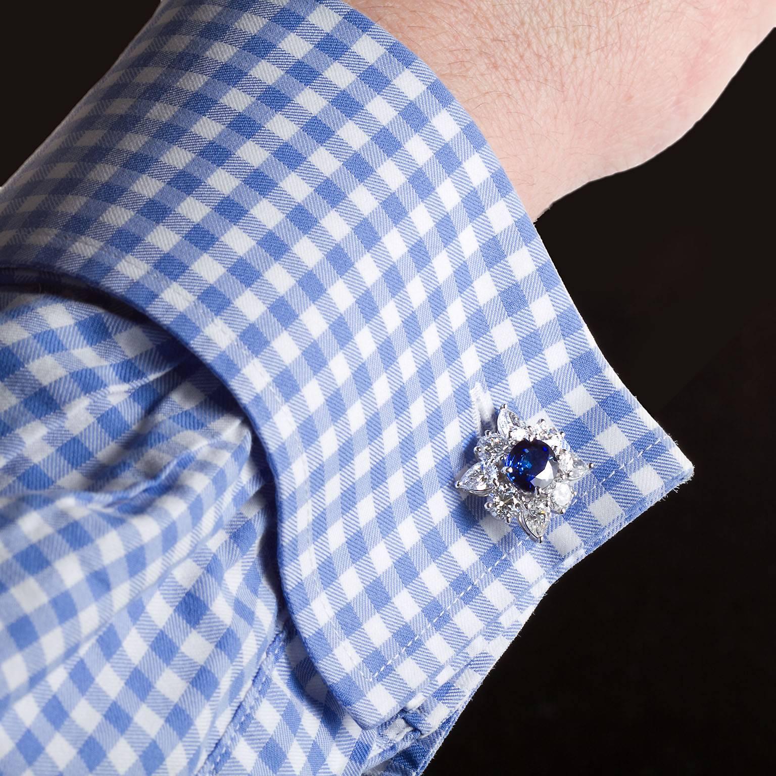 A pair of oval mixed-cut sapphires in diamond cluster cufflinks with accompanying AGL reports. 2.37 and 2.26 cts of sapphires. From Madagascar the sapphires are deep velvety blue with heat enhancement and excellent color stability. Approx. 8.00