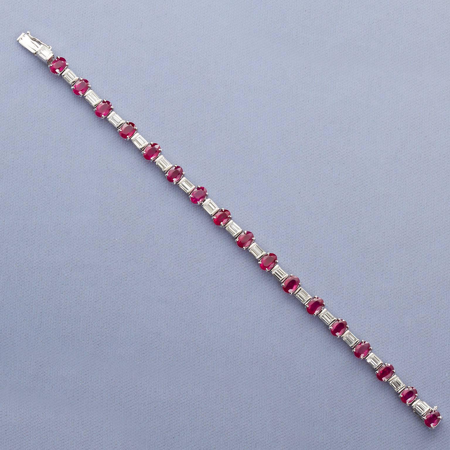 A very fine natural Burma ruby and diamond in platinum tennis bracelet.  Prong set with 17 oval mixed-cut rubies between twin straight diamond baguette links. Approximately 11.50 carats total weight. #warmherheart #warmherhand.
Bracelet measures 7