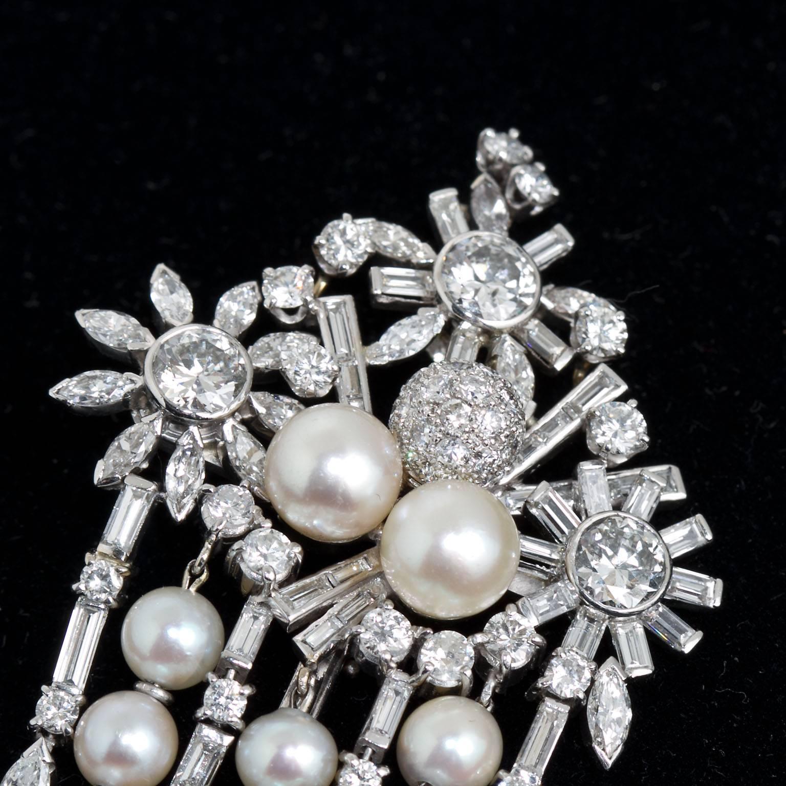 Magnificent. Lavish. Swanky. A most spectacular mid 1900s creation that will tantalize your Art Deco Style and Vintage taste-buds.  This diamond and pearl hanging pendant with diamond pavé balls, pearls, and baguette and round brilliant and