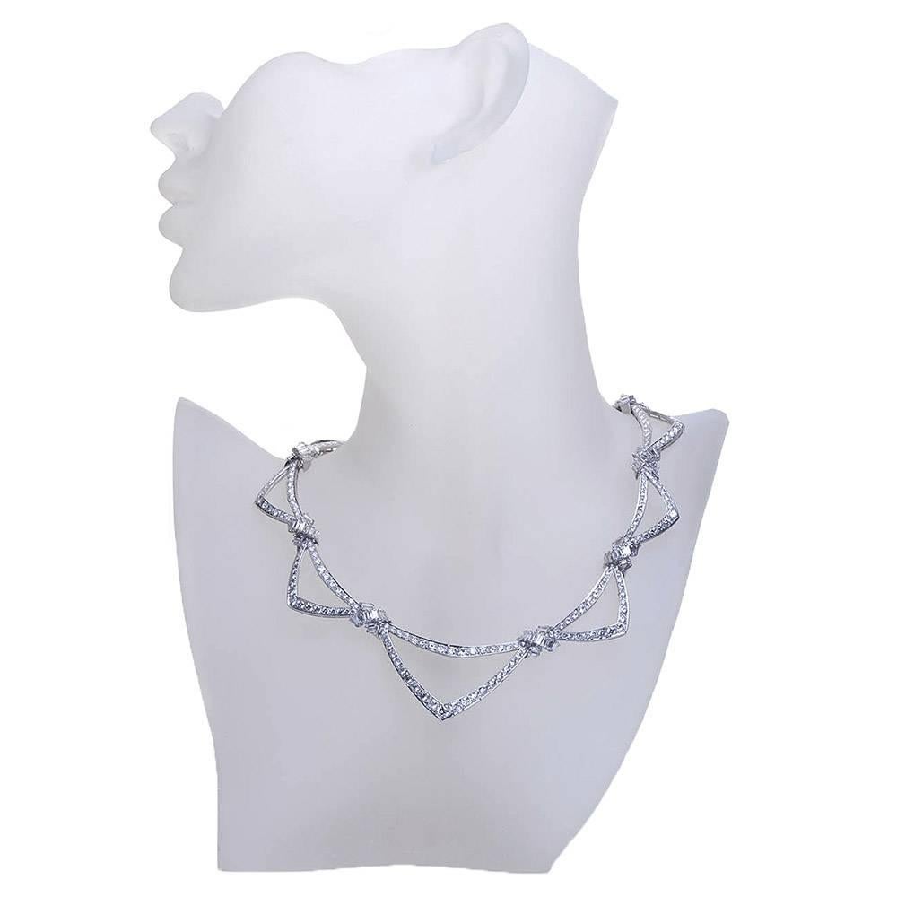 A dramatic neck hugging diamond in 18 karat white gold French crafted necklace. Made of over four hundred individually set round brilliant and baguette shaped diamonds of high collection quality in a very fine articulating setting, this show stopper