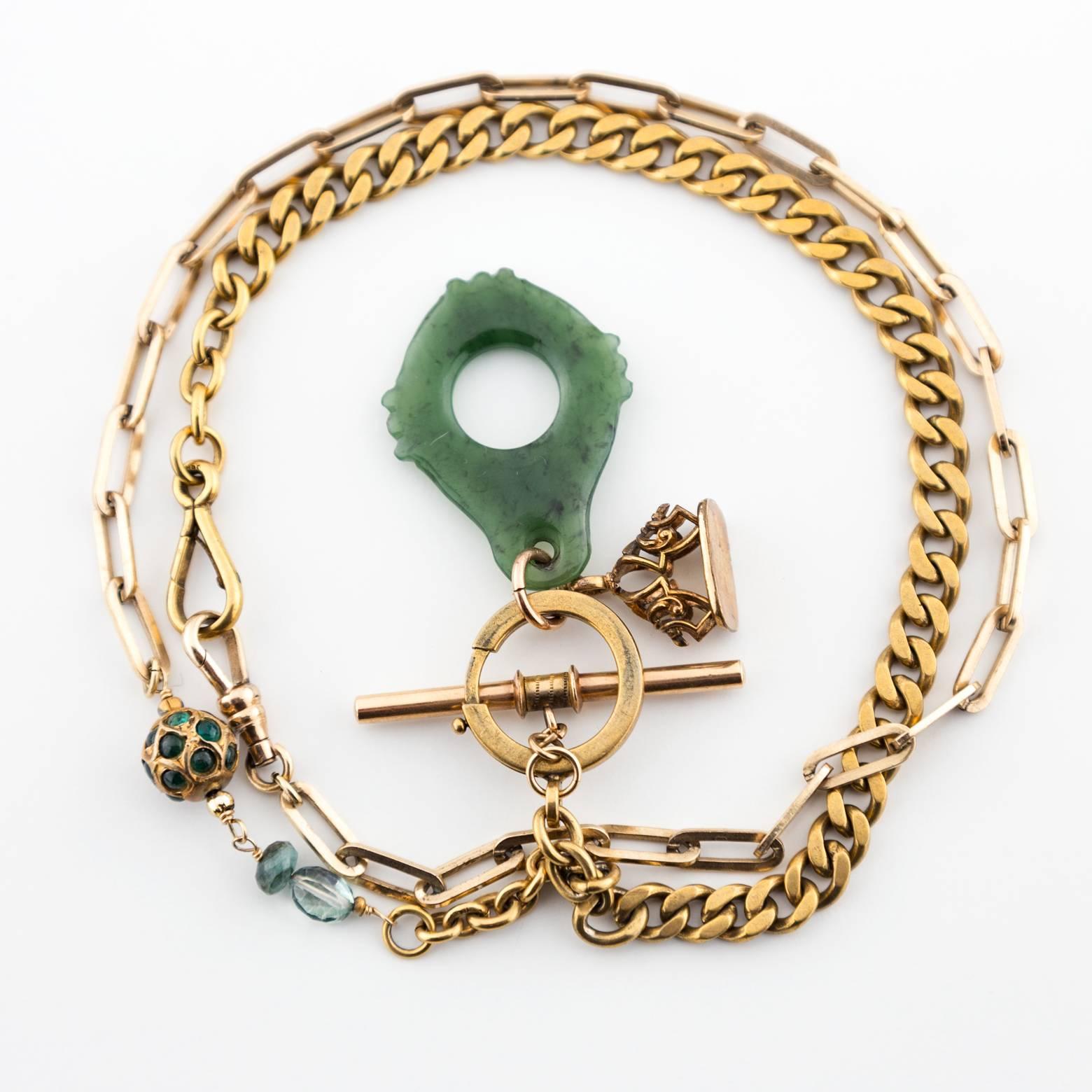 This intricate and detailed chain necklace is full of surprises! Dark Green Jade pendant and tourmaline bring this chain necklace to life! It's uniquely one of a kind strands of gold filled watch fob chains laced together with tourmaline.