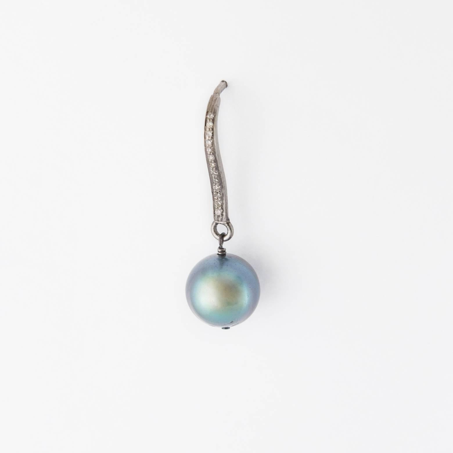 Diamond and Black Pearls from the Cook Islands set in Sterling Silver. Elegant and versatile enough to be worn everyday. The pearls absorb and reflect the colors around it in such a subtle way that they look great with everything. Pearls are 8mm.
