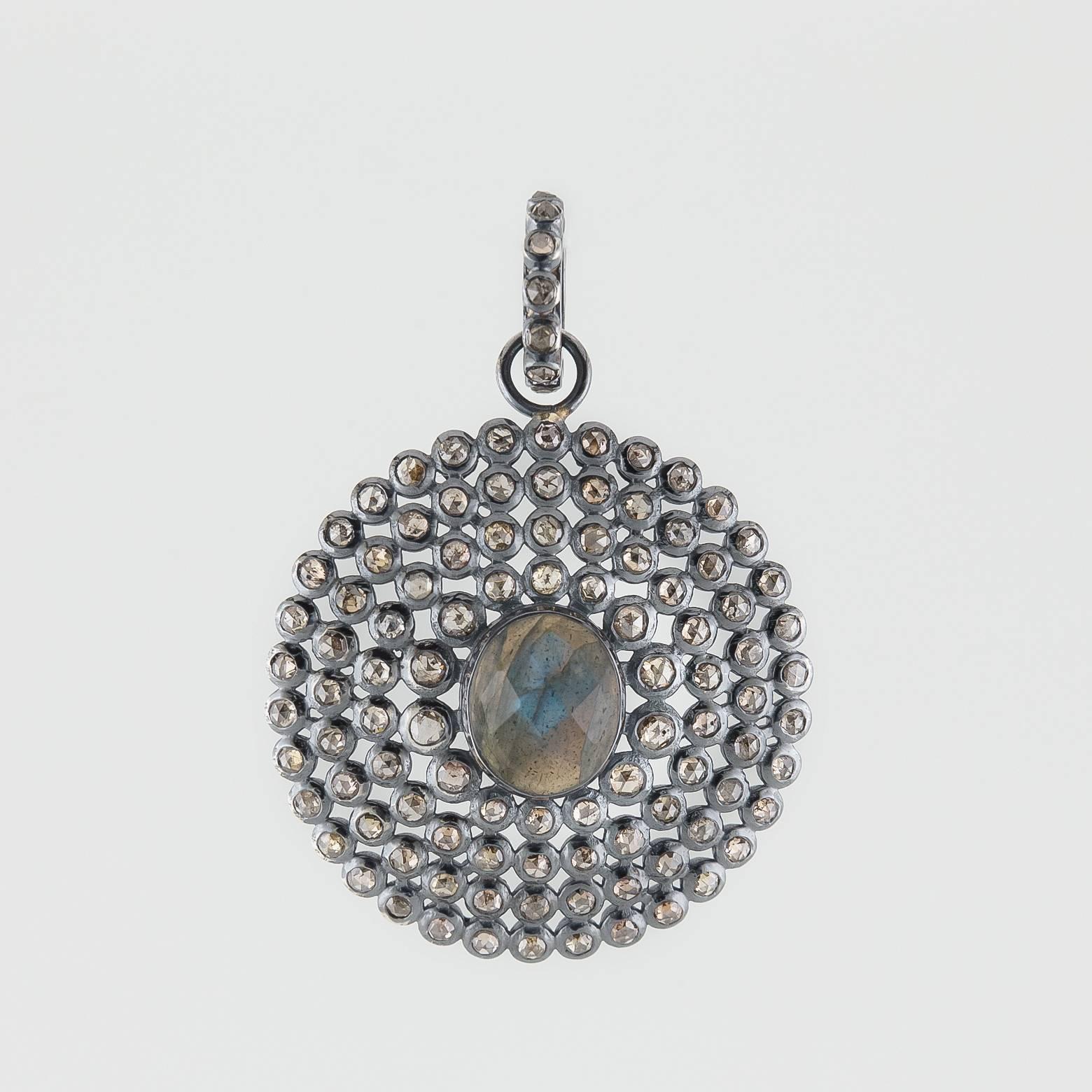Diamonds Galore! This stunning diamond and labradorite pendant has so many diamonds you can't even keep track! They glow from across the room and accentuate the unique glow of this gorgeous labradorite! The oxidized sterling silver lets that sparkle