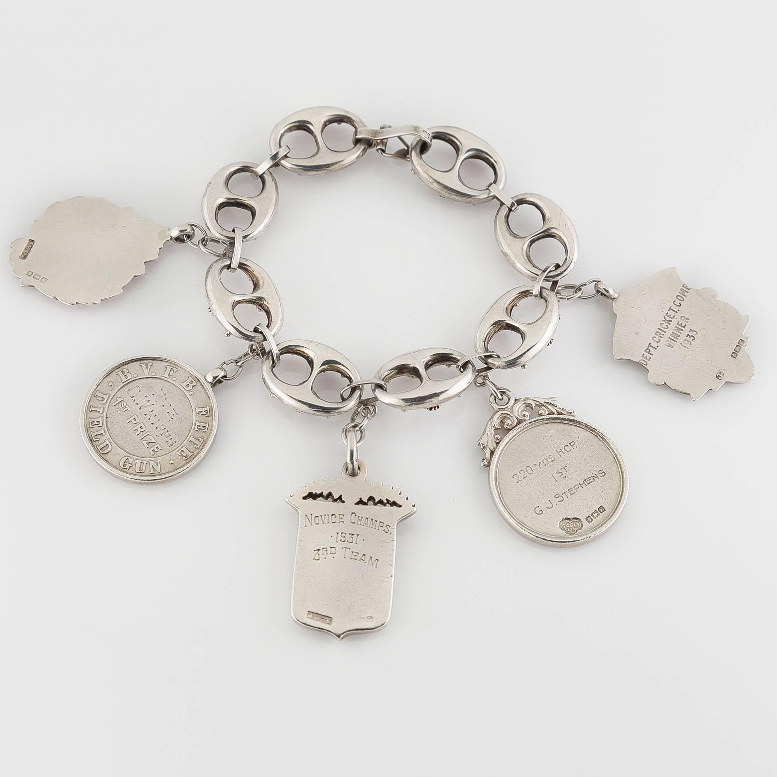 This English Victoiran sterling silver charm bracelet was made in the 1930's and the charms vary from time period- one is as old as 1912. The theme with this charm bracelet is one of sports and has images of soccer and cricket. Fun, sporty and