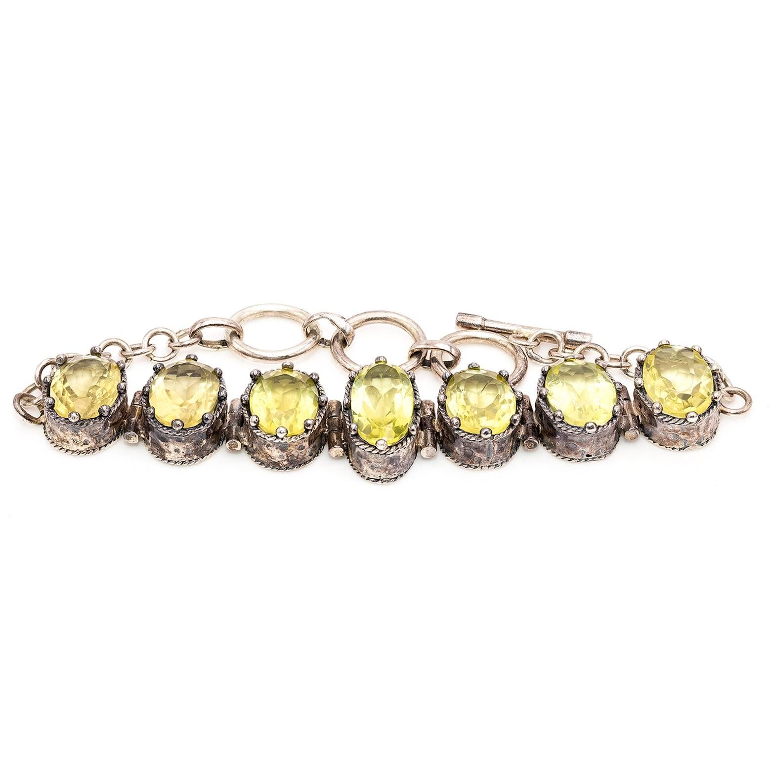 Five large gorgeous rose cut citrine pieces set in sterling silver create a substantial intricate bracelet. The bezel looks regal like a crown and the setting is hammered creating an intricate piece of art that is detail oriented. The size is