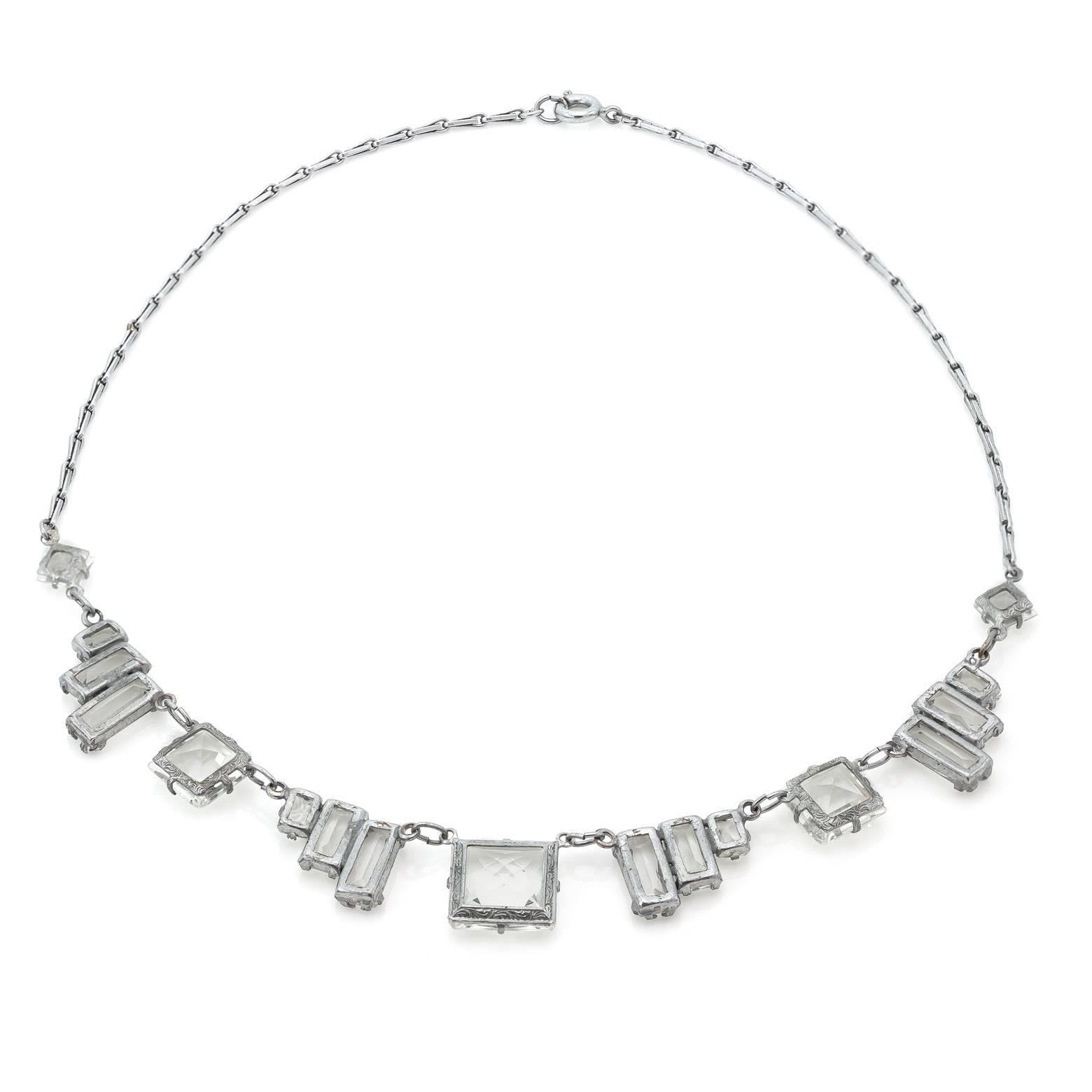This exquisite Art Deco necklace is austere and modern. The glamorous angles create a unique look that is both classic and exciting. The quartz crystals are faceted and reflect light in beautiful colors and the sterling silver chain links are bold. 