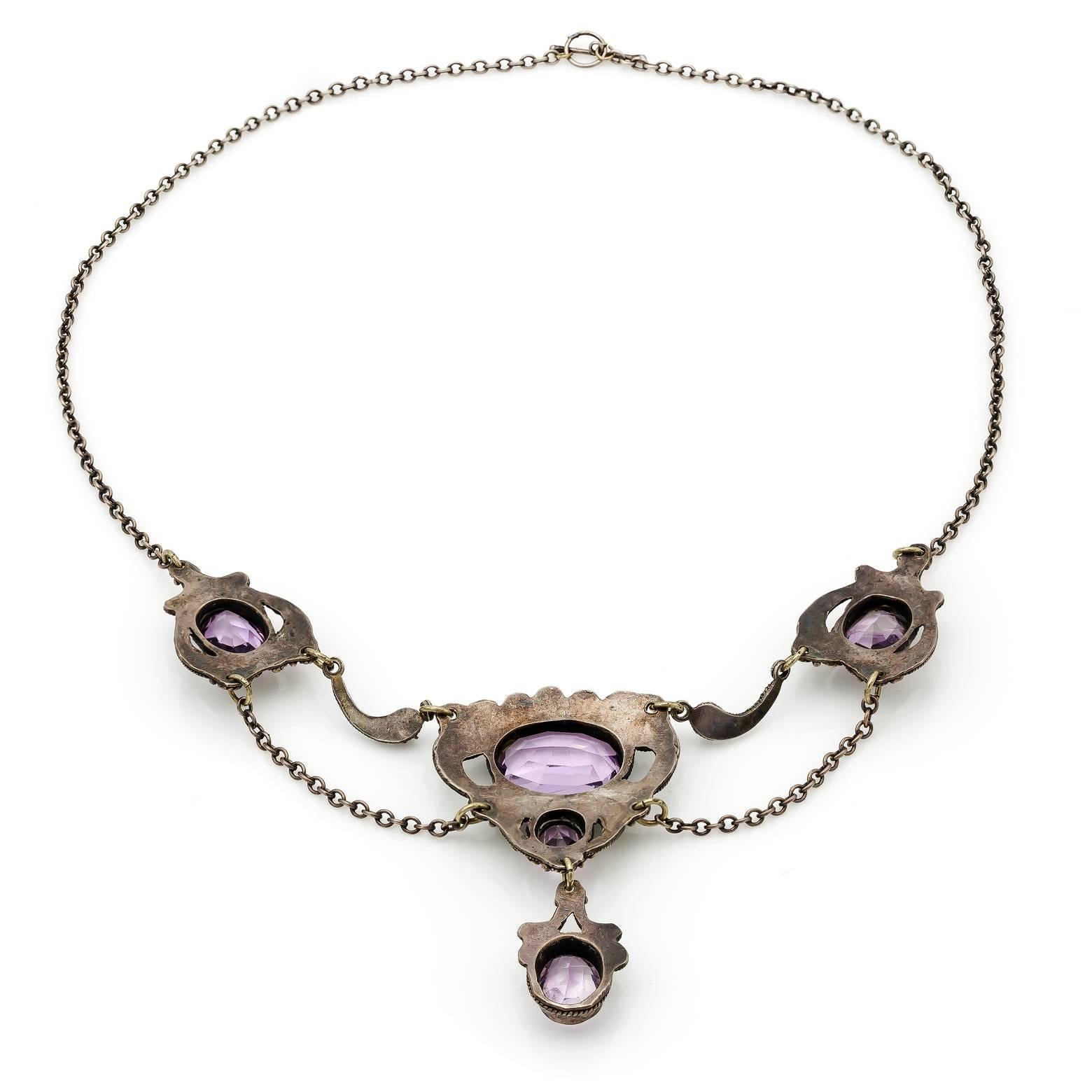 Five gorgeous faceted oval amethysts are held in this highly detailed sterling silver filigree necklace. Handmade and stunning this necklace was made in the 1920's and is a delight to swoon over. Comfortable, elegant and rich in color! 