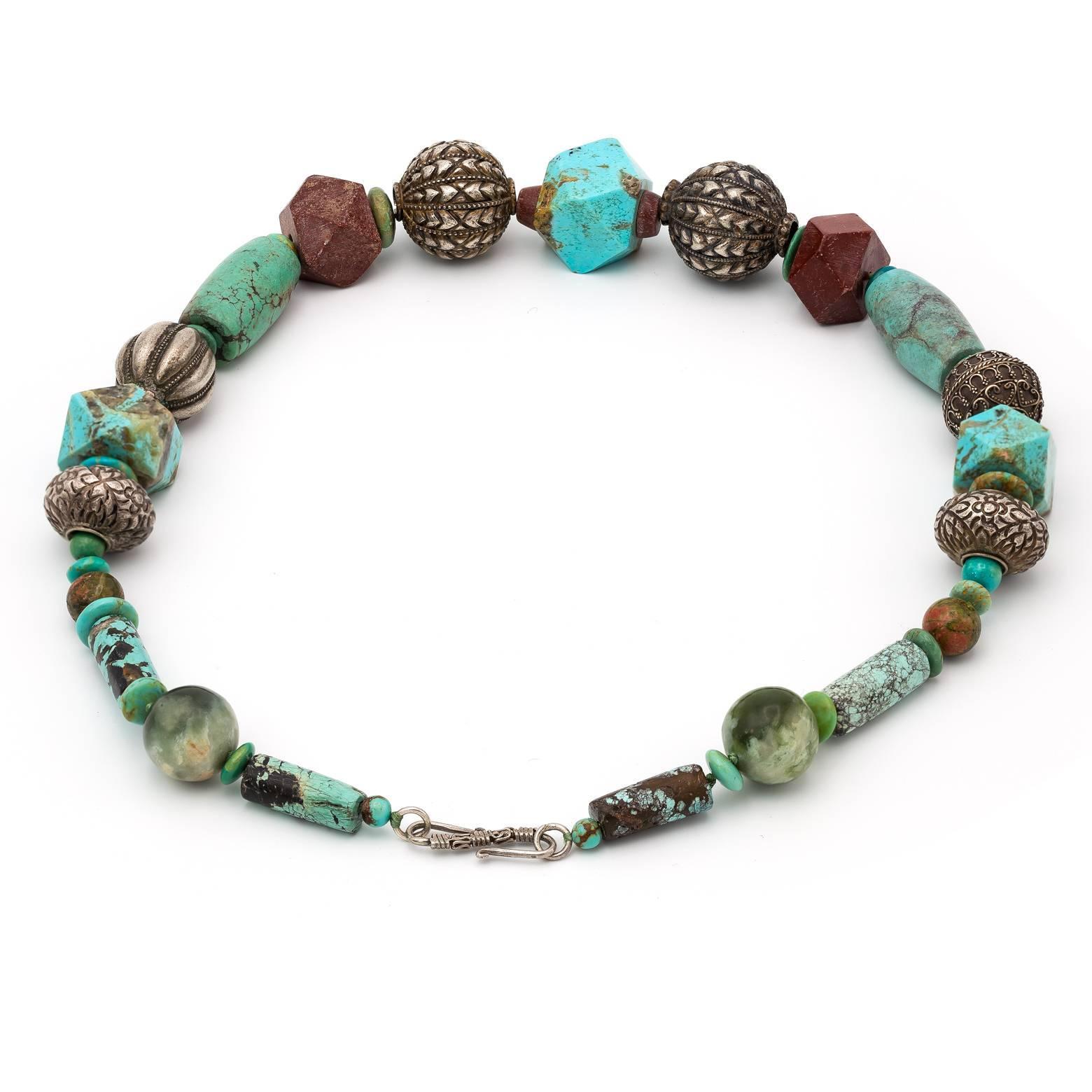 This gorgeous large and substantial beaded necklace is a statement piece that can transform any outfit into something greater. The turquoise and jasper beads are in all shapes and sizes and are complimented so well with the intricately detailed