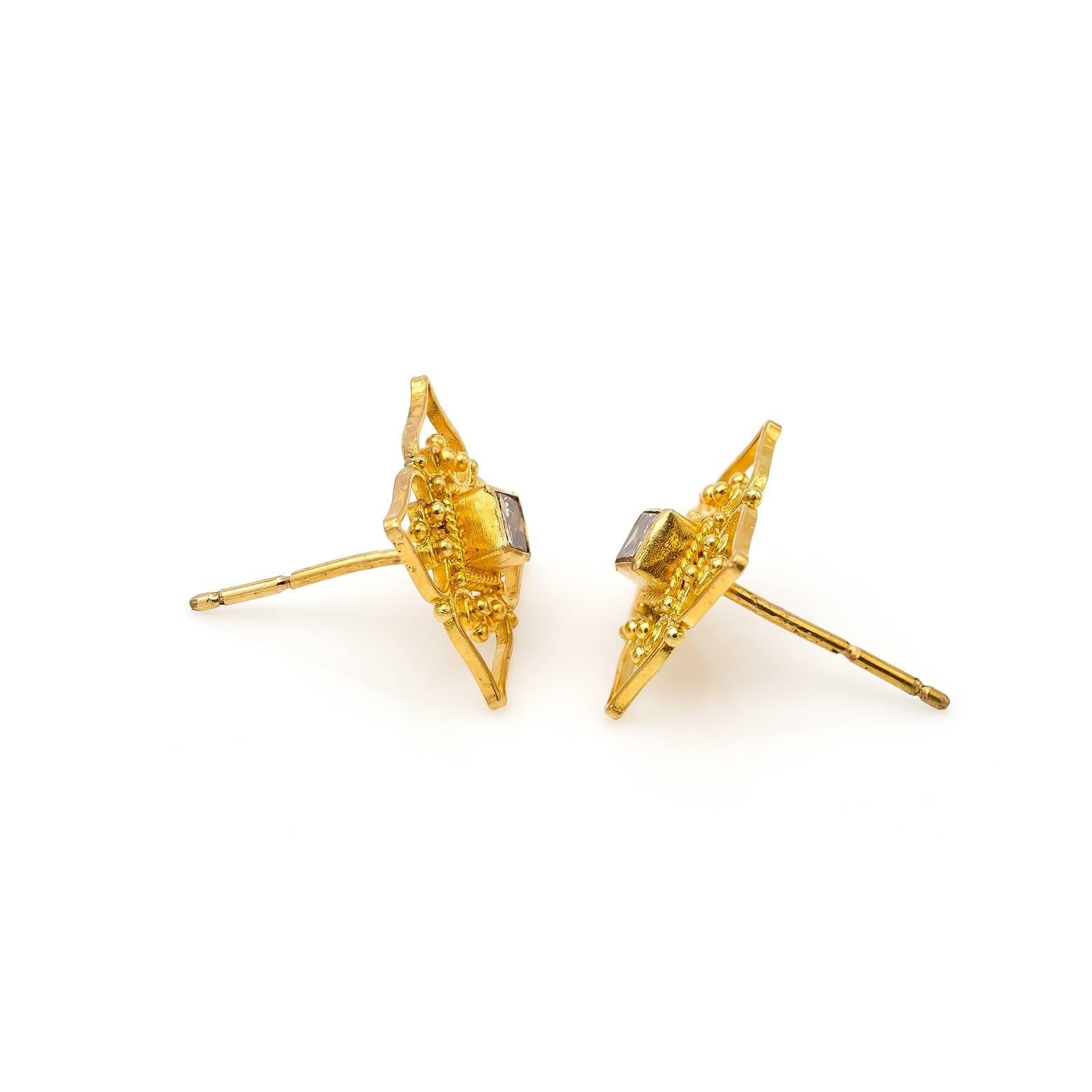 These gorgeous 22K yellow gold filigree studs are intricate and adorned with princess diamonds in the middle. The beautiful champagne color is stunning and the design is absolutely marvelous. The total carat weight for the diamonds is 0.17