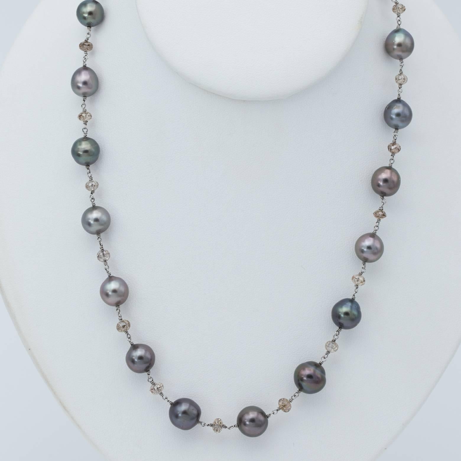 19 black pearls and 20 champagne faceted diamond beads create this gorgeous elaborate necklace. The total weight of the diamonds is ~18.36 carats and the pearls are an average of 10mm. Set in 18K white gold with a white gold clasp adorned with white