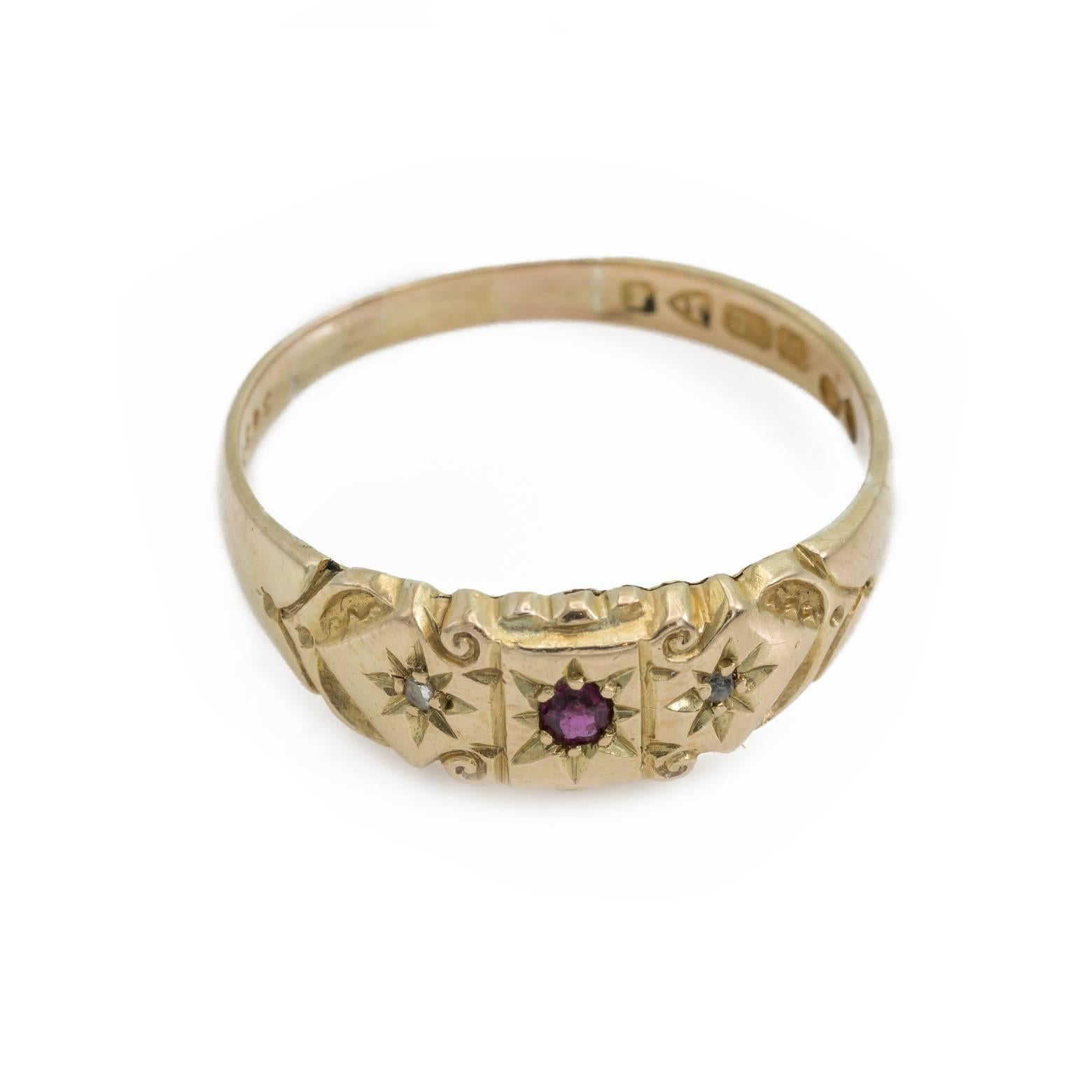 This stunning ruby and diamond band ring was made in 1905 and is in perfect condition. The detail work is engraved with spirals and stars creating a magical and enchanted look to it. Size 10.25 and may be sized 18K Yellow Gold. 