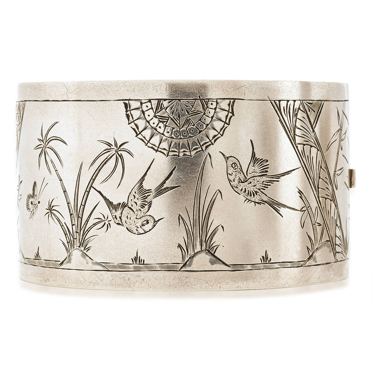 This stunning bracelet is hand crafted in England. The exact date is not known but is from the 1880's. The etching is of birds and the geometric accents modernize the total look.  The width is 1 1/2" high and the oval shape is comfortable on