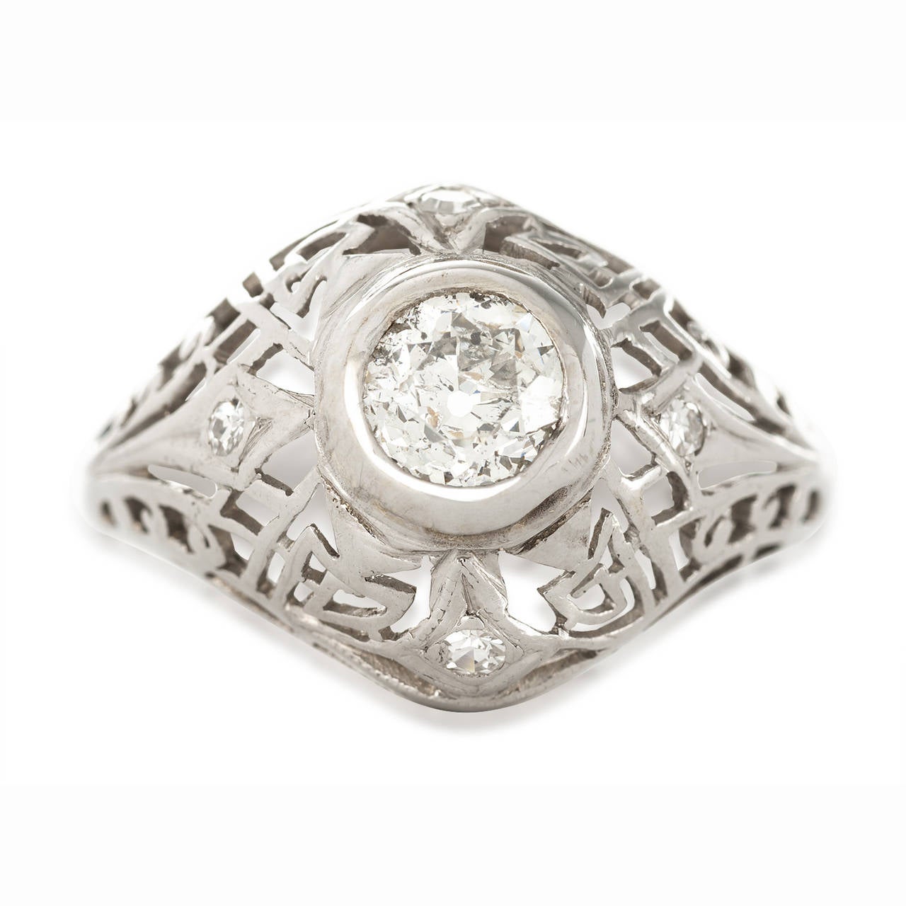 This stunning filigree and diamond ring would make a wonderful wedding ring for a woman who is confident. The center diamond is .40 tw G color and SI1 quality surrounded by four diamonds set into the filigree design. The ring size is a 6 1/2.