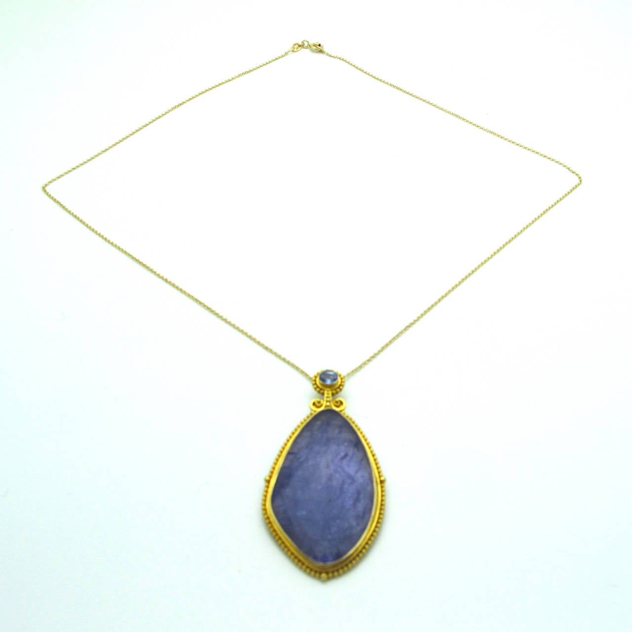 Modern Tanzanite Sapphire Gold Drop Pendant For Sale