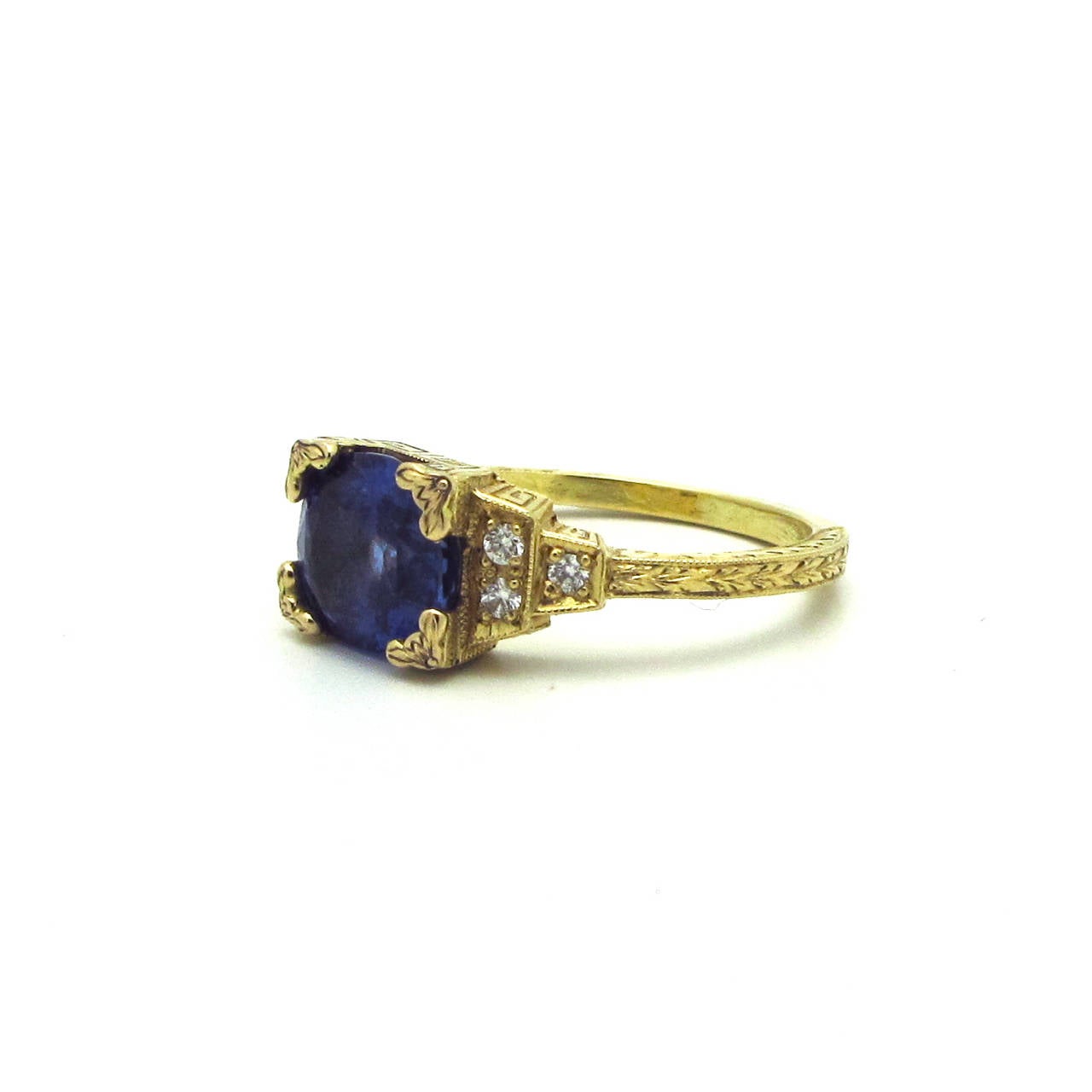 This beautiful Sri Lankan sapphire 3.80cts and diamond 0.12cts ring was made especially for M. Lowe Jewelry by a master goldsmith. The ring is 18 k yellow gold with exquisite hand engraving throughout. It is unusual to find yellow gold in the Art