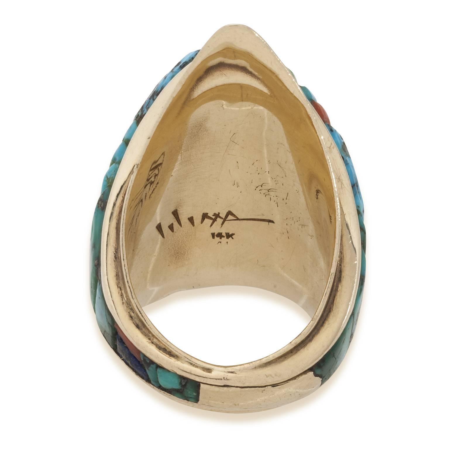This Charles Loloma ring is intricately inlaid with turquoise, coral and lapis.Set in 14K gold it is an exceptional example of his work. Hopi Indian and a well known craftsmen he is world famous and his style is easily recognizable.The ring size is