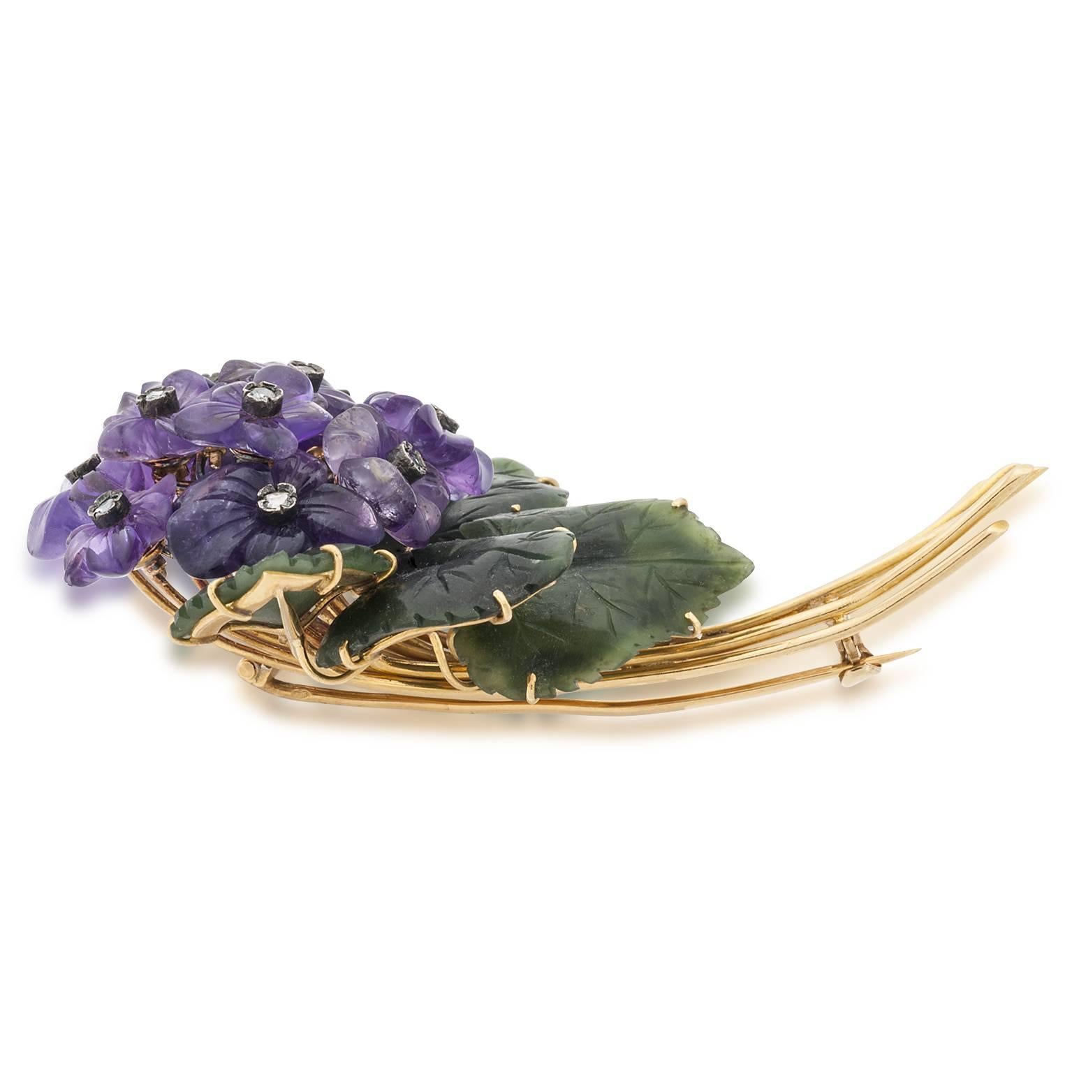 This floral pin is hand carved with leaves of Nephrite jade and amethyst flowers. The center of each flower is set with a rose cut diamond in a sterling bezel.The detail is really amazing and exceptional!! 