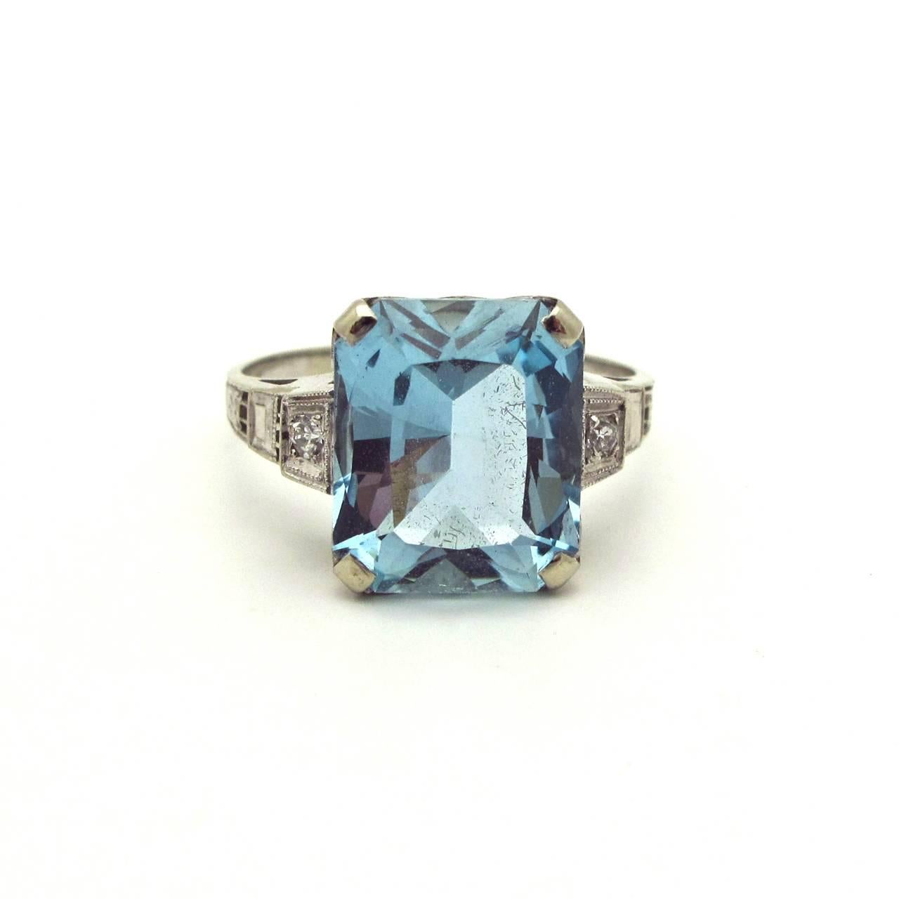 This stunning aquamarine emerald cut stone is a deep aqua blue. Accented by diamonds and set in white gold the combination is perfect!! This would make an exceptional engagement ring or just a lovely stunner to wear everyday.
