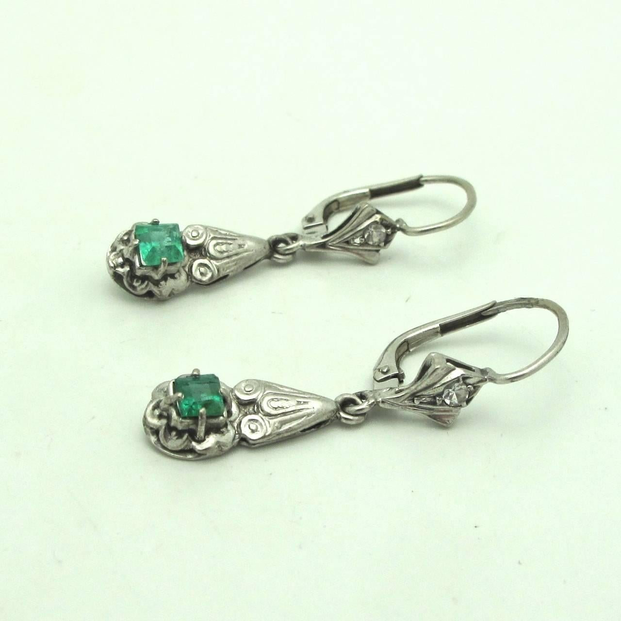 Stunning and Retro these diamond and emerald earrings are classic enough to wear everyday but also dressy for that special occasion. These are a great investment! The diamonds are .025 ct ( .050 tw) each and the emeralds measure are .20 ct each for