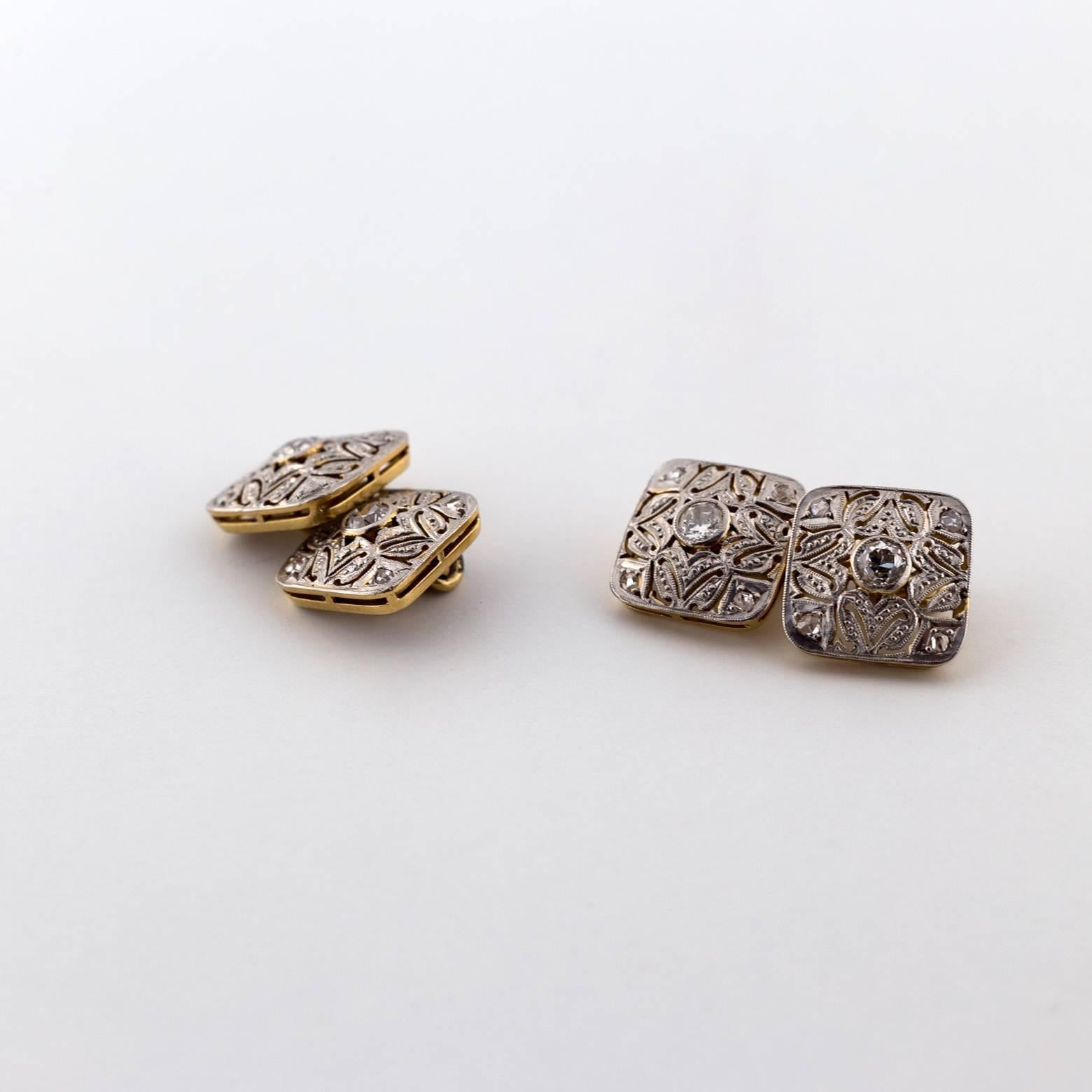 Stunning and vintage white and yellow gold cuff-links 0.65 total weight of diamonds with the center stones as old mine cuts and the four accent diamonds on each cuff are rose-cuts. 20 diamonds total!